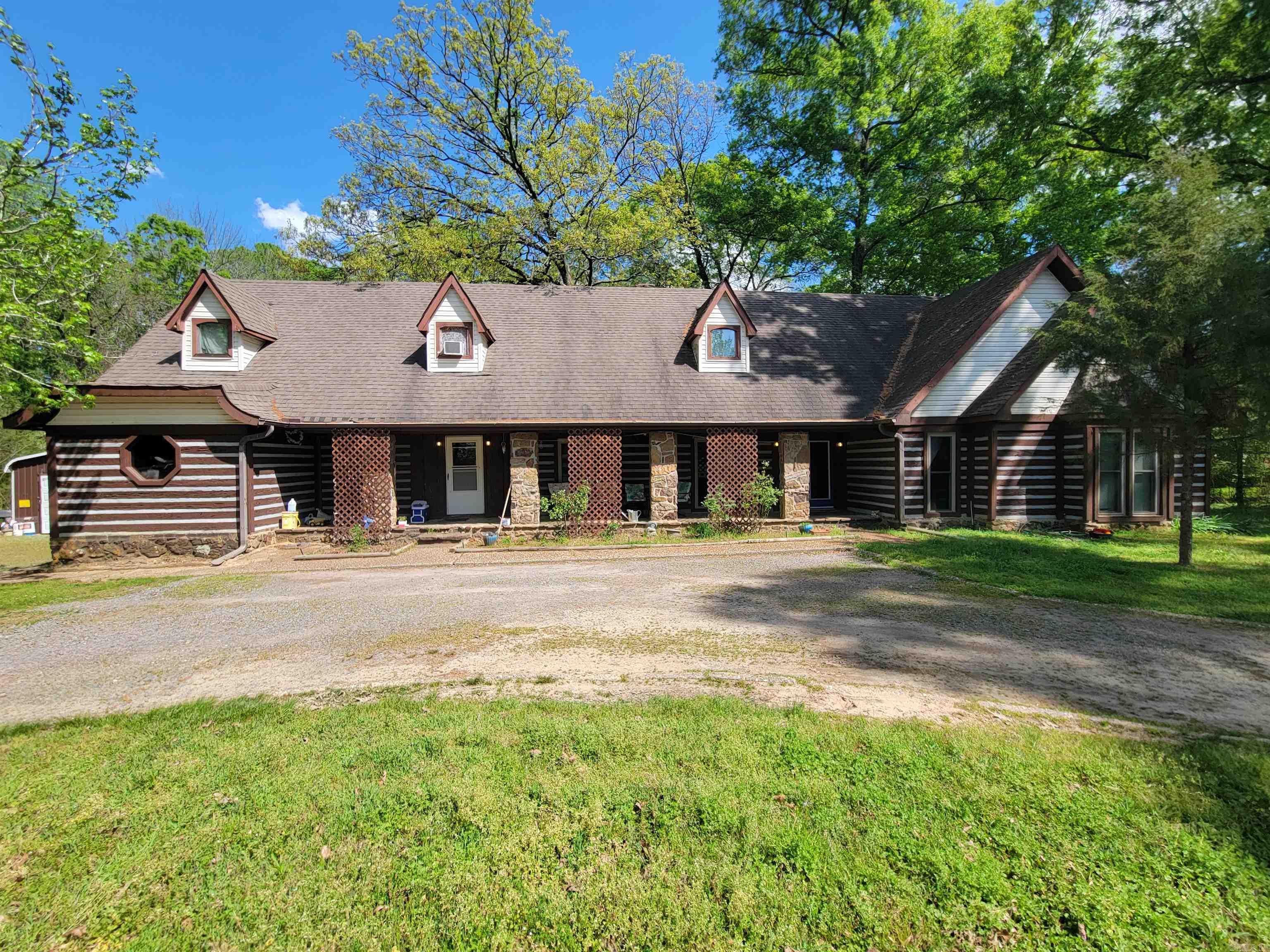 This unique property sits on a spacious 2.41-acre lot that backs directly up to Wooster Community Park—offering both privacy and convenient access to outdoor recreation. The home features 3 bedrooms on the main level, including an original primary suite with a private bath. Upstairs, you’ll find a custom-designed primary bedroom complete with double closets and its own private bath, creating a flexible living arrangement. Inside, you’ll notice distinctive touches like stone flooring and custom wood tile accent walls that add character throughout the home. The kitchen has been recently updated, while the rest of the home offers a great opportunity to renovate and make it your own. Attic space with two extra rooms-perfect for bedrooms, an office, or a bonus room.