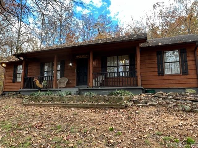 Your dream of a quiet home in the woods, surround by the best views can now come true. Whether you are sitting on the front porch in your rocking chairs or grilling out on the back deck, the solitude, scenery and wildlife will amaze you. This 5 bedroom, 3 full bath home includes 2 master bedroom suites with custom vanities in all the baths. The open living/dining area is great for entertaining. The kitchen is just right with a new dishwasher and the cutest droplight over the sink. The shop is a huge 30 x 40 ft. with 2 garage doors and 220 and 110 electric; perfect for the craftsman or mechanic in the family. The rock retaining wall and steps lead up to a little garden shed and then on up to the top of the mountain for a view that is to die for. Newer paint, floors and hot water heaters inside, as well as newly painted doors and porch outside. You don't want to miss this one. Schedule your showing today!