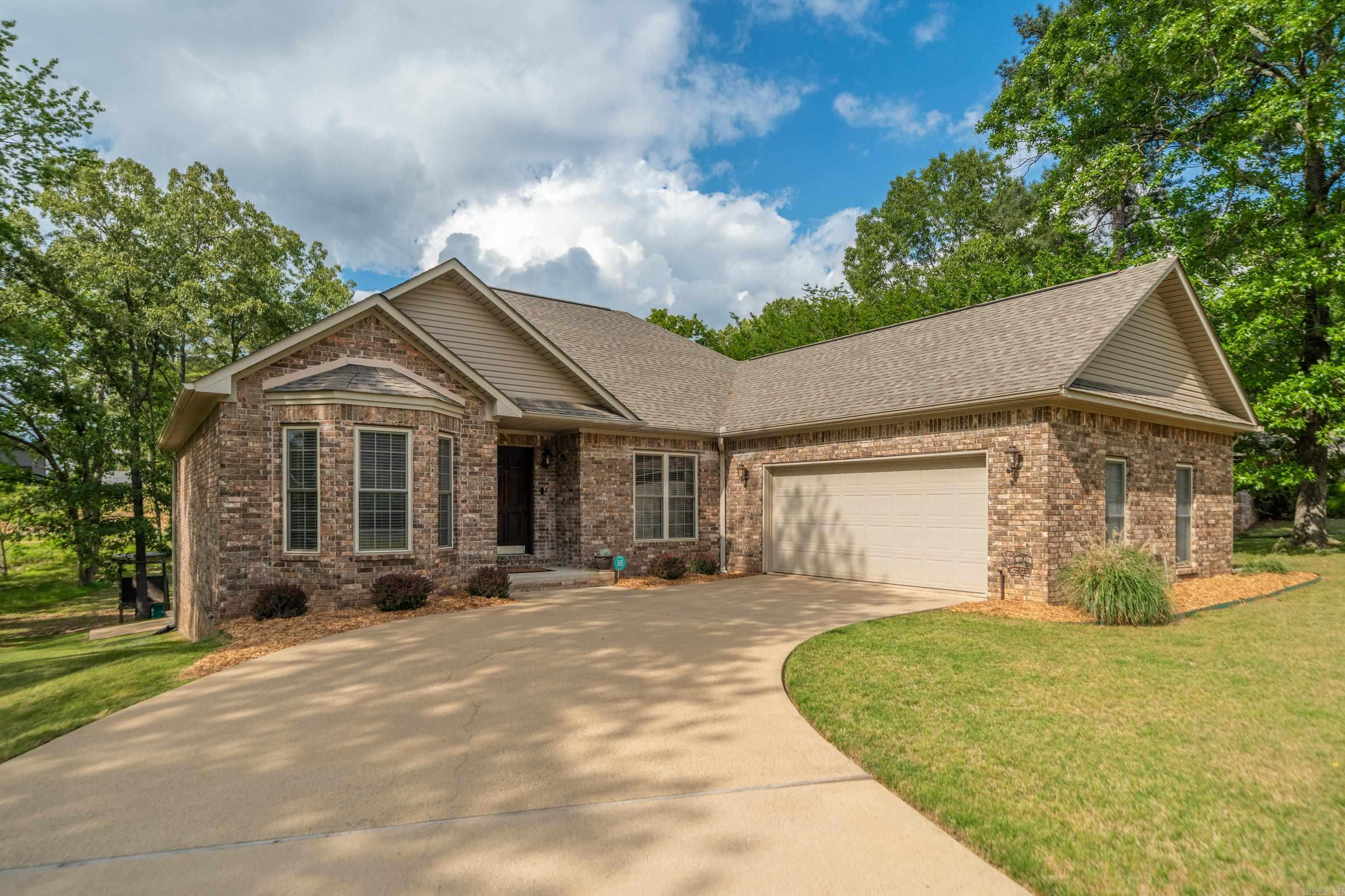 Welcome to your retreat just a stones throw from Lake Hamilton! This inviting 3 bedroom 2 bath offers the perfect blend of comfort and convenience. Features a spacious split floor plan, 2 car garage, separate dinning room, downstairs storage and covered back porch. All on almost half an acre lot! Within walking distance to Hill Wheatley Park, that features a boat ramp, walking trail and sand beach! This meticulously maintained home has a new roof (2024), leaf guard gutters and a sprinkler system to keep your yard green all summer!