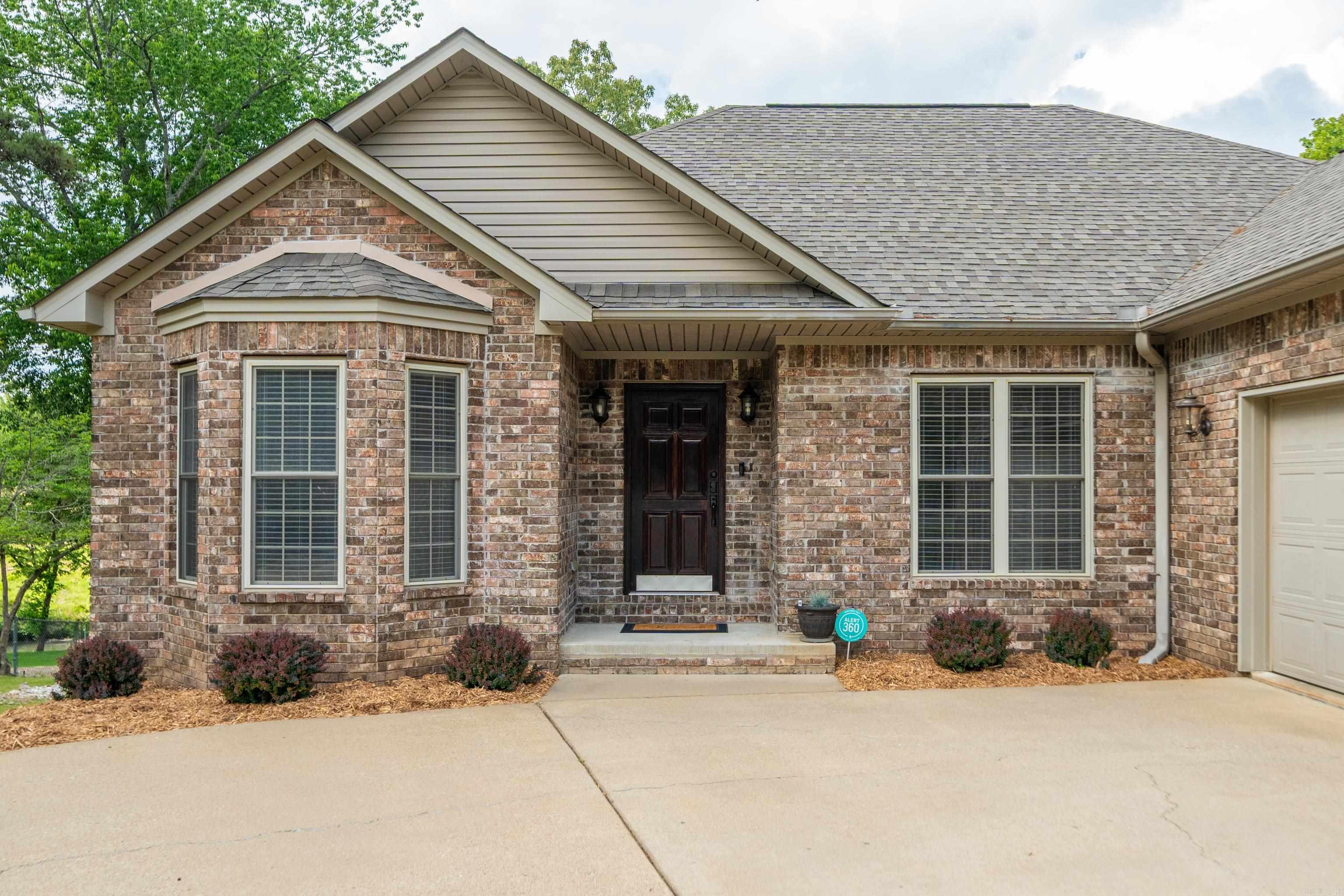 Welcome to your retreat just a stones throw from Lake Hamilton! This inviting 3 bedroom 2 bath offers the perfect blend of comfort and convenience. Features a spacious split floor plan, 2 car garage, separate dinning room, downstairs storage and covered back porch. All on almost half an acre lot! Within walking distance to Hill Wheatley Park, that features a boat ramp, walking trail and sand beach! This meticulously maintained home has a new roof (2024), leaf guard gutters and a sprinkler system to keep your yard green all summer!