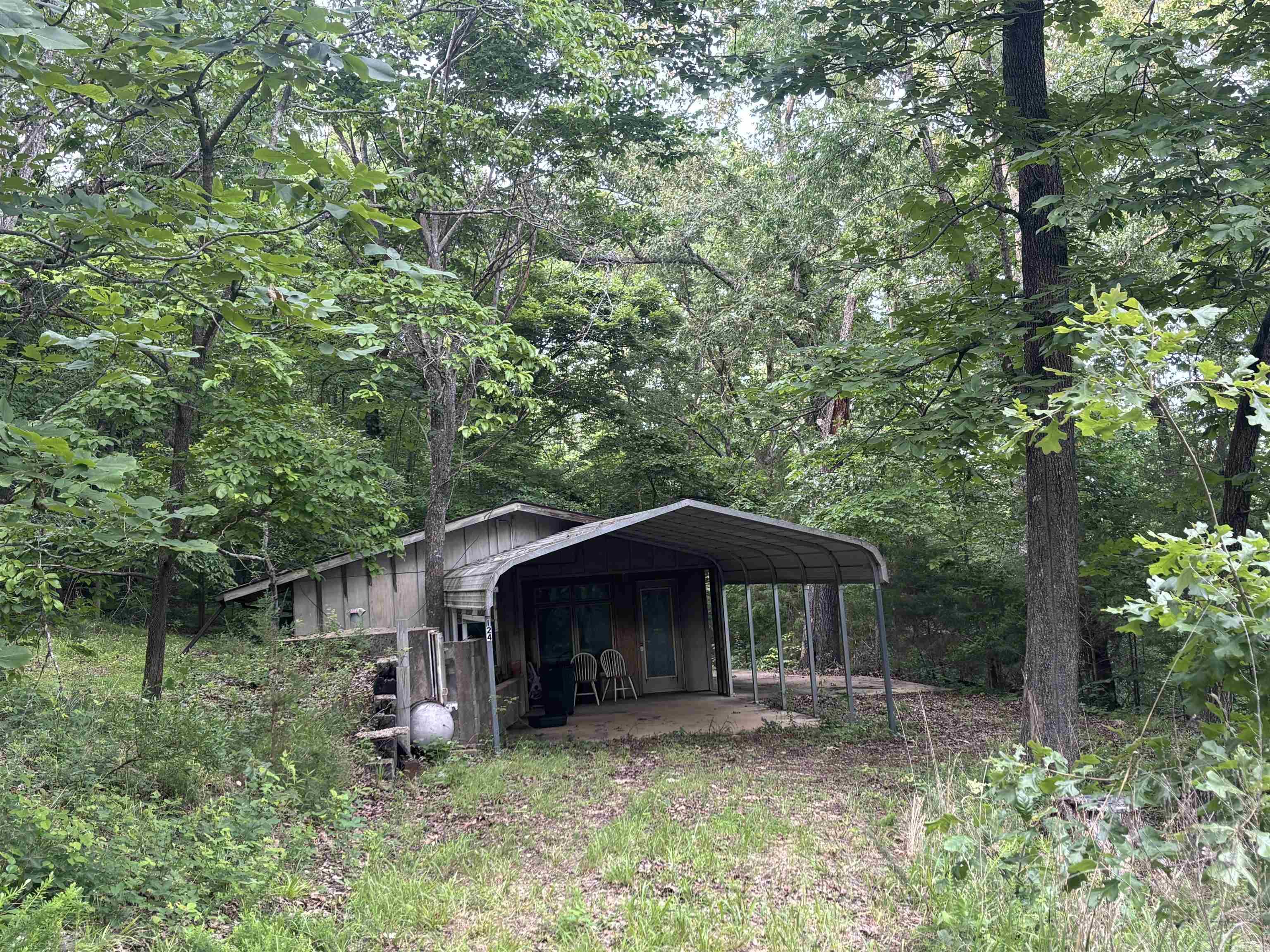 River area! Privately located! This hidden gem is only 2 mi MOL from 2 the most popular Trout Resorts on world renown White River in the beautiful Ozarks and minutes from the Court Square where the Folk Music Capitol of the World's music rings loud on weekends and during the many festivals held year-round. The mostly wooded 4.79 acres MOL features a cozy furnished 1 bedroom cabin, 1 bath with walk-in shower and stackable washer/dryer, a living/kitchen area, sunroom entrance, storm shelter, and carport cover over a concrete slab creating a spacious sitting/outdoor living space with gorgeous woodland views for enjoying morning coffee or quiet evenings. One of the best features is the 24X36 shop building complete with a car lift and office area! This building could also be converted into additional living quarters, an overnight rental, office, game room, or for business use. Blanchard Springs Caverns and thousands of acres of Ozark National Forest are just up the road so if you're looking for a place to enjoy the best of the Ozarks whether as a vacation or second home, for retirement, RV, or for a nightly rental investment, this property offers numerous options in an ideal location!
