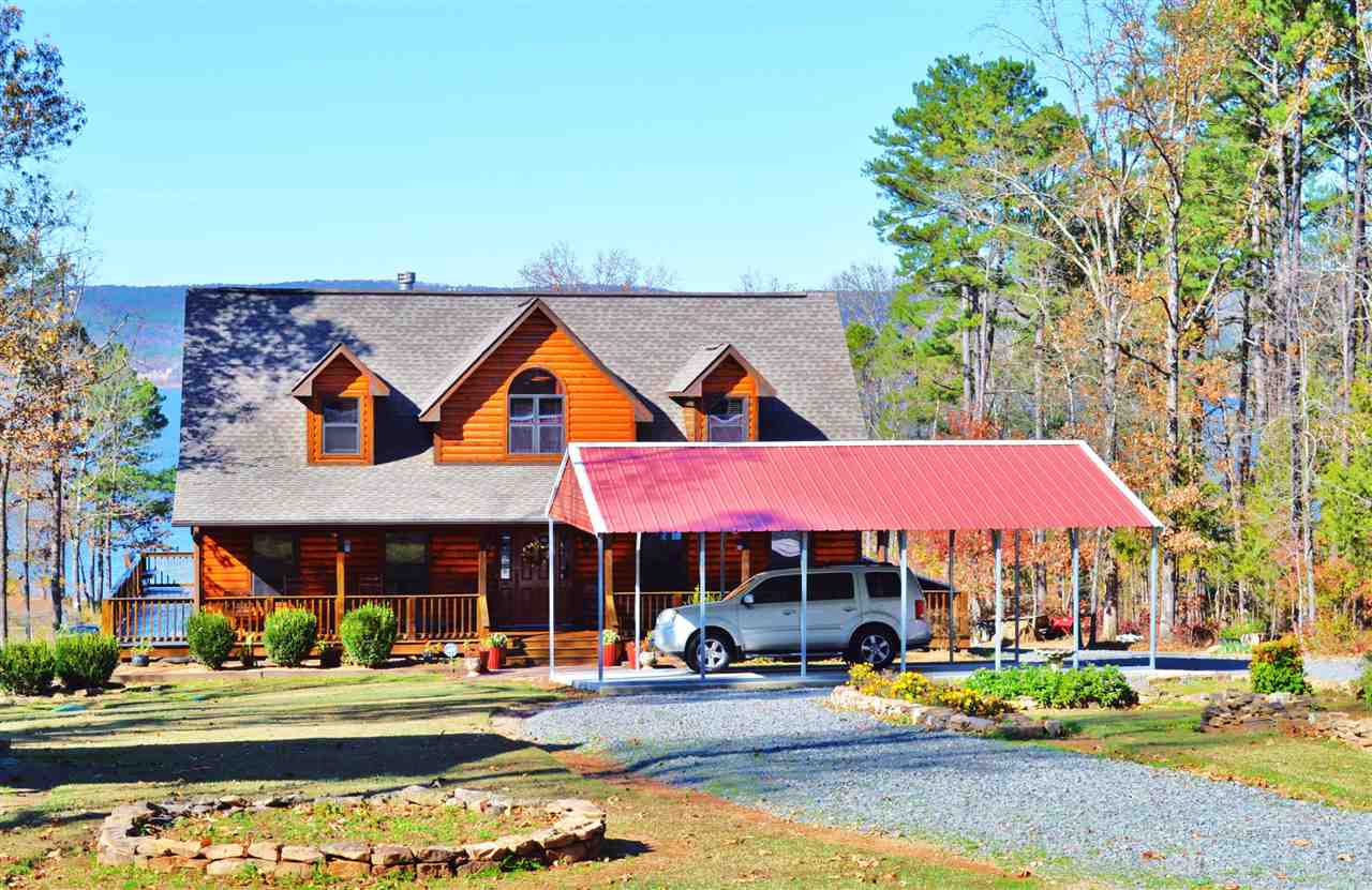 Looking for that "purr"fect lake getaway? Look no farther!! This gorgeous, log sided home is waiting just for you! 3 large bedrooms, 2 1/2 baths, huge vaulted wood ceiling, lots of windows(with great view of the lake and mountains) & beautiful gas log fireplace in living area,open to a well equipped kitchen, granite counter tops, & large eating area.Master suite w/lg. master bath, on main floor and two large BR's up. Easy walk to the water& a great beach area. Marina's nearby. MAKE OFFER!! Owner anxious!!
