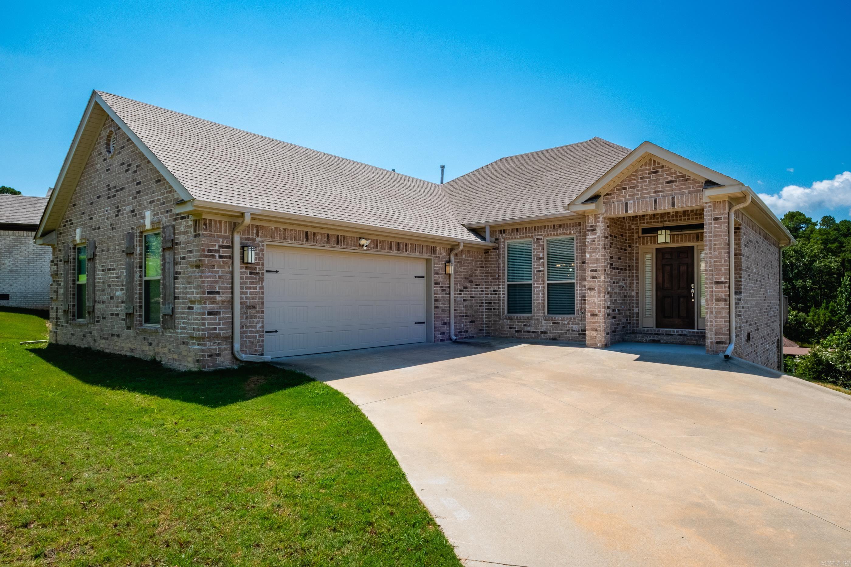 Brick 4 BR home w/ 10' ceilings and beautiful finish features. Crown moldings & custom window & door trim. Stainless Frigidaire appliances & slab granite in kitchen w/breakfast bar +  separate breakfast area with bay window. Good cabinet space plus a pantry. Inviting entry opens to a more formal dining area and flows into the greatroom w/ gas log fireplace. Spacious primary bedroom w/ tray ceiling and bath w/ oversized walk-in closet with built-in storage shelves. Double size tiled shower plus tub and granite double vanity. Powder room for guests on main level and laundry w/ storage cabinets on main level. Extra large garage opens to main floor. Garage has nice finish features w/ clean epoxy floor + a mini-split unit for heating & cooling making it an ideal "man cave". Enjoy the view from the deck opening from the greatroom. Downstairs area includes 3 bedrooms + a storage closet w/ access to the crawl space.  1 BR down large enough to be used as a bonus/gameroom and  offers access to the backyard. 2nd full bath w/ shower over tub and double granite vanity. Extremely nice well-maintained home and so clean - move in condition! Wonderful recreational facilities in Maumelle community.
