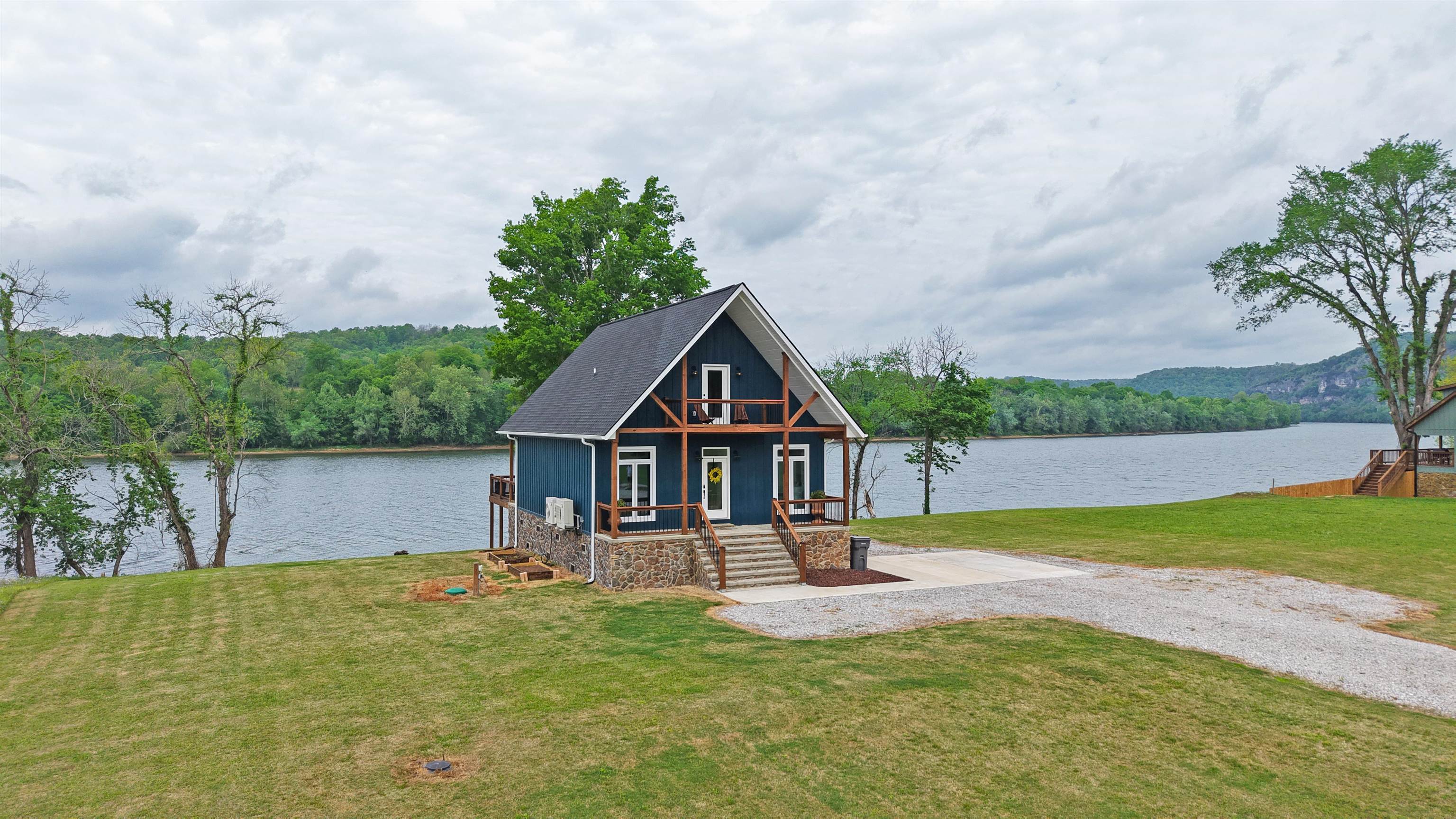 Built in 2024, this like-new 3-bedroom, 2-bathroom riverfront home offers approximately 1,368 square feet of living space on the banks of the White River, with all paved road access and a drive of less than twenty minutes to Batesville, Arkansas. The main living areas and many of the windows face toward the river, allowing the living room to function as primary viewpoints for the water, iconic bluffs, and surrounding landscape.  A dedicated laundry room adds everyday convenience, and includes a move-in ready appliance package in the kitchen. Outdoor living is a key feature, with the back deck positioned to overlook the White River. There is abundant wildlife that can be seen regularly from the property, such as bald eagles, river otters, beavers, ducks, geese, and deer along the river corridor.  The river setting supports a range of recreational activities, including bank and boat fishing, kayaking, canoeing, and leisure boating on nearby stretches of water, making the property suitable for owners seeking both a residence and an outdoor-oriented lifestyle. This 0.6 acre river lot and home is listed for only $385,000.