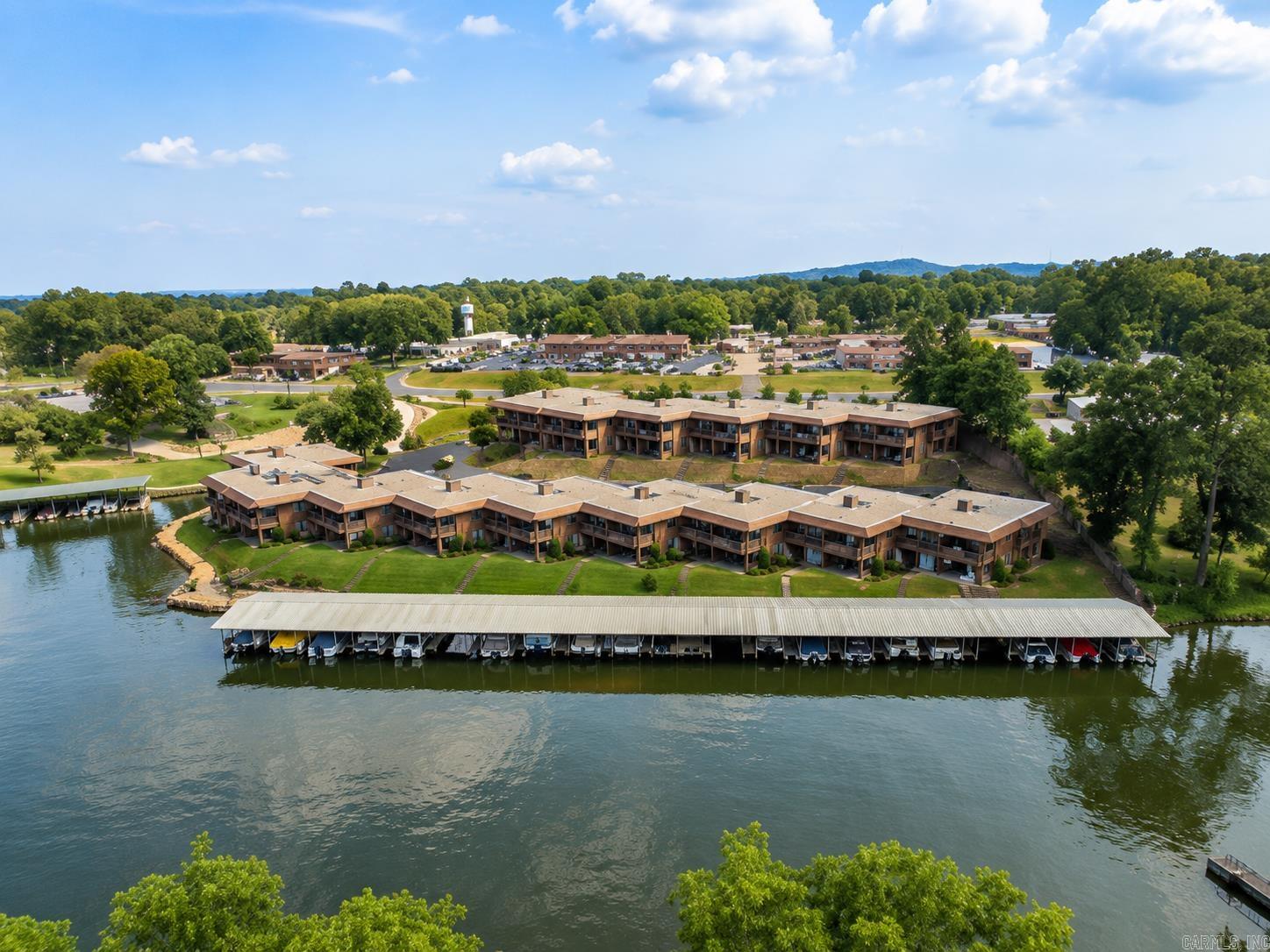 Welcome to lake life at its finest at The Harbor on Lake Hamilton.  This beautifully remodeled 2 bed, 2 bath retreat offers the perfect mix of luxury, comfort, & relaxation.  From the cozy stone fireplace to the designer kitchen finishes, custom wood countertops, & high end luxury stove and refrigerator, every detail was thoughtfully designed to create a warm & inviting space. Enjoy peaceful outdoor living with a patio made for morning coffee or evening sunsets, all while taking in a sneak peek view of Lake Hamilton & mnts.  Nestled inside a gated community, this property delivers the perfect balance of privacy, charm, & lake retreat energy. Boat slips are also available to lease for even more enjoyment on the water, & residents can enjoy community amenities including a swimming pool perfect for summer days at the lake. Come live where the horse races are legendary, the casino is just minutes away, & Bathhouse Row is enjoyed year-round. Whether you’re looking for a weekend escape, investment property, or full-time lake living… this is the Hot Springs lifestyle everyone dreams about.  Pictures are beautiful… but the feeling you get when you walk in is even better.