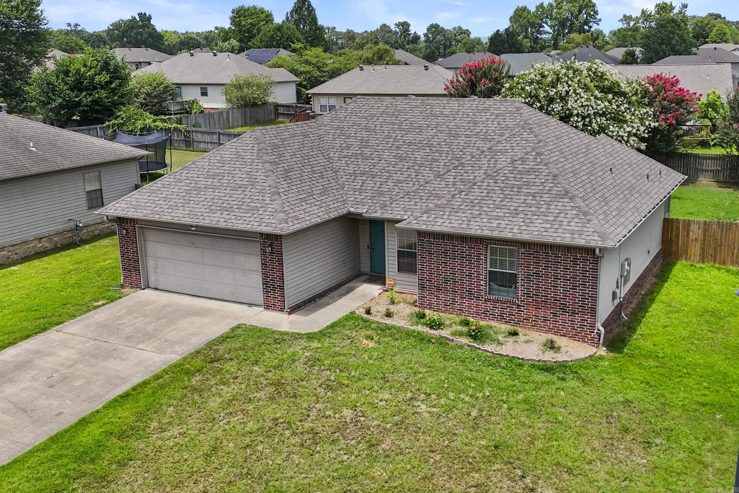 This move-in ready Cabot home in Blooming Ridge subdivision offers a great open floor plan with comfortable spaces throughout. The living room features a corner gas log fireplace, creating a warm and welcoming feel as soon as you walk in. The kitchen provides plenty of space, great storage, and opens nicely to the dining area with a beautiful bay window. The primary bedroom is a good size, and the primary bathroom offers separate vanities, a jetted tub, walk-in shower, and his and her closets. Outside, enjoy a covered patio overlooking the large privacy-fenced backyard, perfect for relaxing, entertaining, or letting kids and pets play. Located in a great subdivision with a two-car garage, this home is a wonderful option for anyone looking for comfort, space, and a convenient Cabot location.