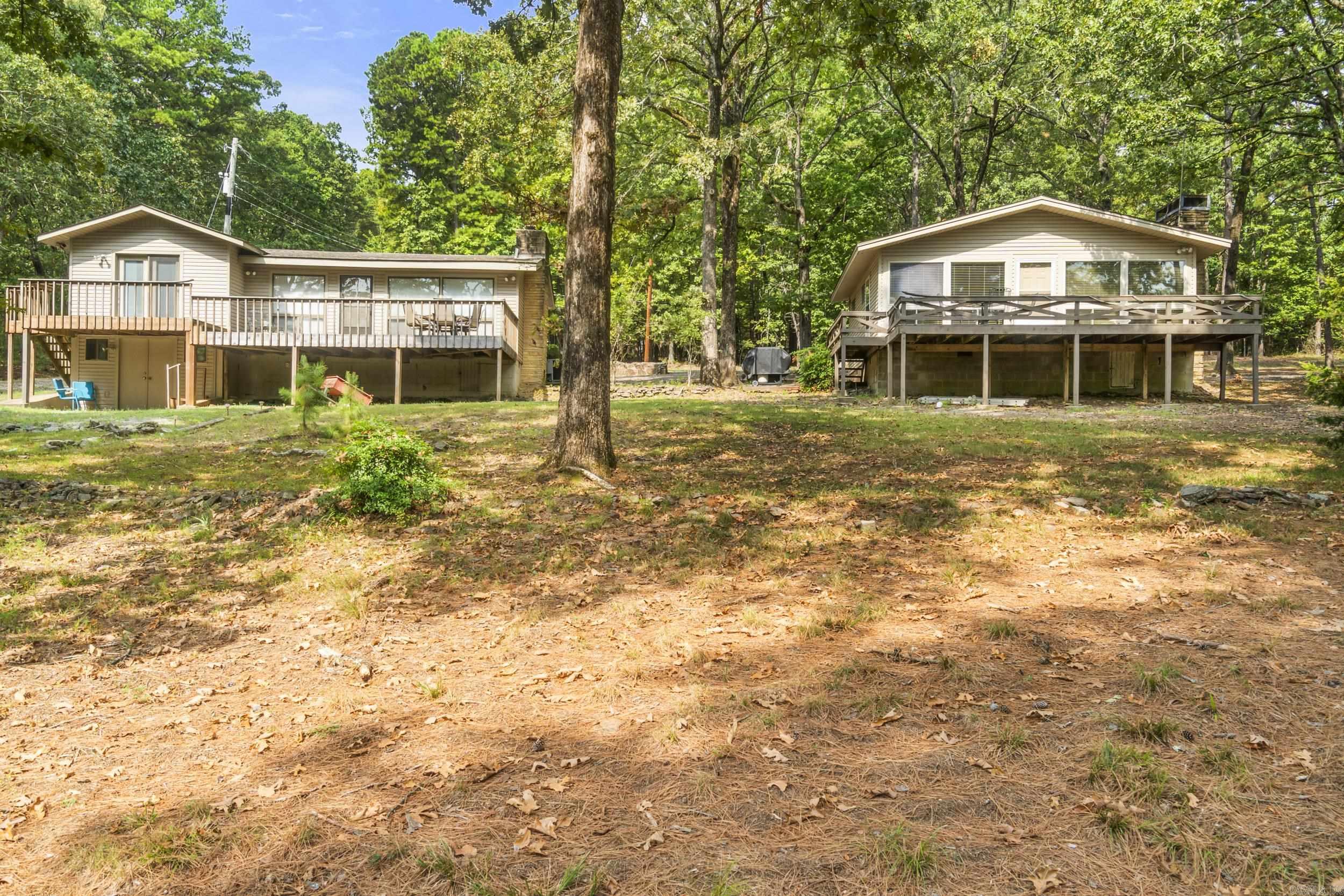 Secluded Lakefront Retreat – 2.36 Acres on Beautiful Greers Ferry Lake Two charming cabins nestled on 2.36 private acres, just minutes from Heber Springs Marina. Perfect as vacation rentals or your own private getaway. One cottage offers 2 bedrooms and 2 baths, while the other features 2 bedrooms and 1 bath. Both have cozy wood-burning fireplaces for your enjoyment. Relax on the property and take in one of the best views of the 4th of July fireworks over the lake!