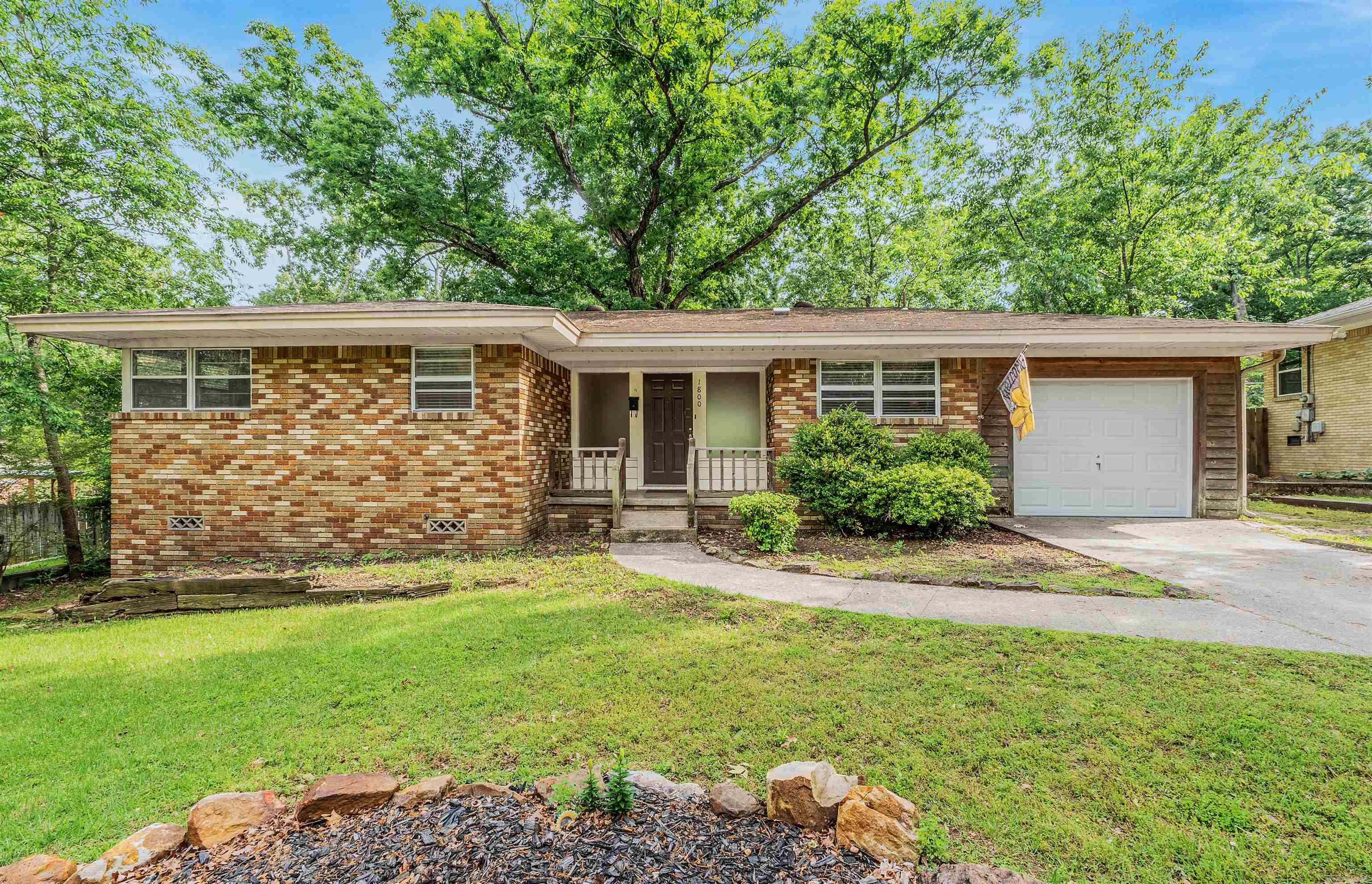 Welcome to 1800 Northwood Road, a charming home nestled in the established Lakewood subdivision of North Little Rock. This inviting single-story property of comfortable living space with a functional and easy-flow layout. Featuring three bedrooms and a cozy atmosphere, the home is filled with natural light and hardwoods throughout.  The eat-in kitchen provides a perfect spot for everyday meals, while central heat and air ensure year-round comfort. Step outside to enjoy a level lot just under a quarter acre, complete with a patio for relaxing or entertaining, a fenced yard for added privacy, and an attached garage for convenience.  Ideally located near schools, shopping, and major roadways, this home offers the perfect blend of quiet neighborhood living and accessibility. Whether you’re searching for a first home, downsizing, or investing, this Lakewood property is full of potential.