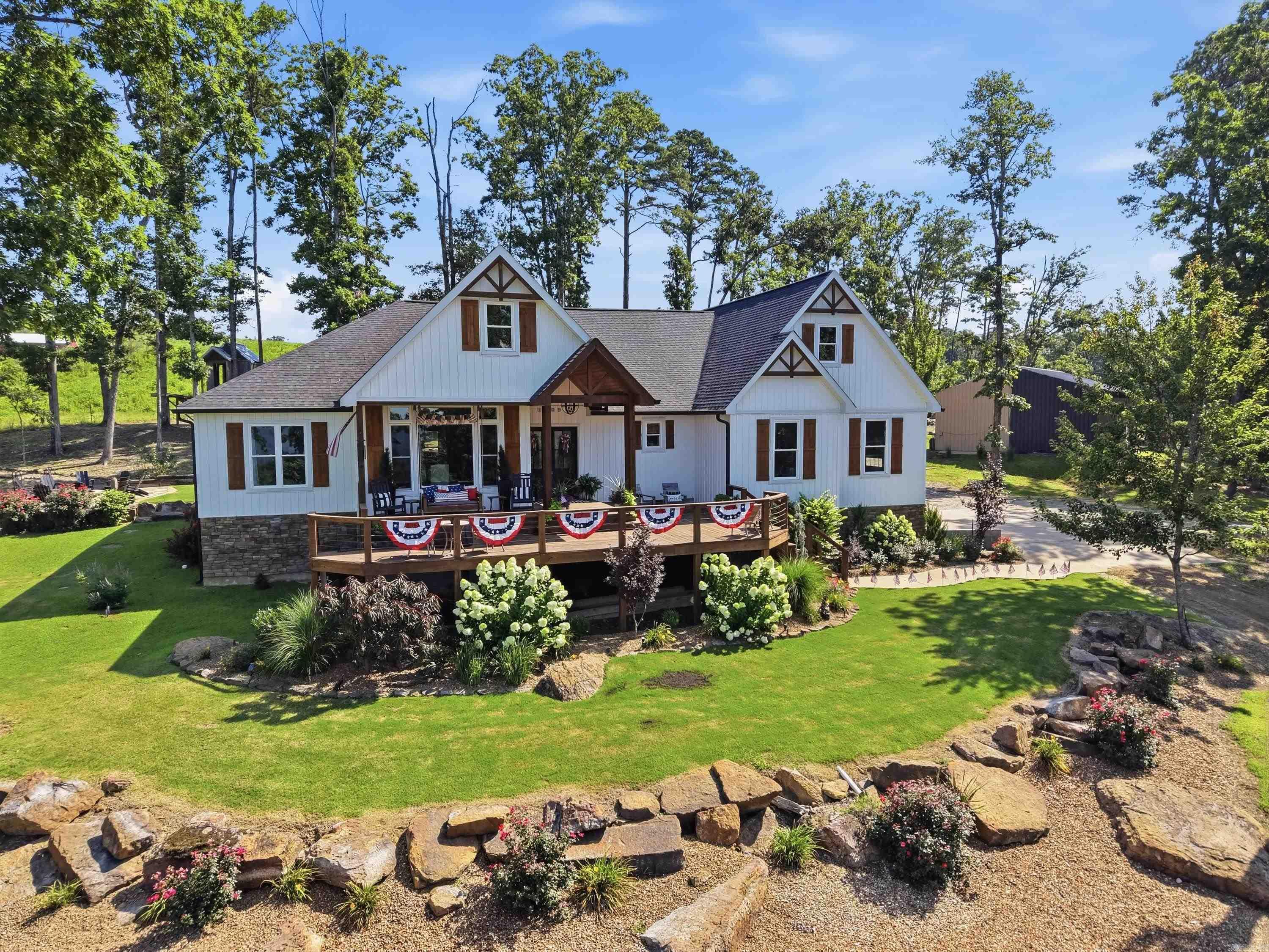 Beautiful Custom Built Home sitting on 10.38 acres w/Views of Greers Ferry Lake & Sugarloaf Island.Sit on your front porch, feel the breeze as you lookout over the lake. There is a 30x40 shop for your lake toys or can be finished out as a guest apartment (Owners stayed in the shop while they built their home, so it already has a kitchen, full bathroom & floored upstairs).This Home has many custom upgrades that add so much character from the exposed beams & cathedral style ceilings to the Designed accents walls throughout the home, under cabinet lighting, hidden walk in pantry w/organized shelving & undermount oven (2nd oven for those that love to cook/bake), large Picture window in dining room with a view,oversized Breakfast Bar, custom cabinets, custom tile work throughout,Primary closet built-ins, tongue & grove wood features inside & outside. All Kitchen appliances stay.Excellent Split Floorplan with Primary suite on one side, guest bedrooms on the other,plus Bonus Room over garage that they currently use as a playroom/music room but could also be used as a 4th bedroom. There is a covered back porch, open patio, treehouse, Built in firepit, & a garden area  (pool does not stay).