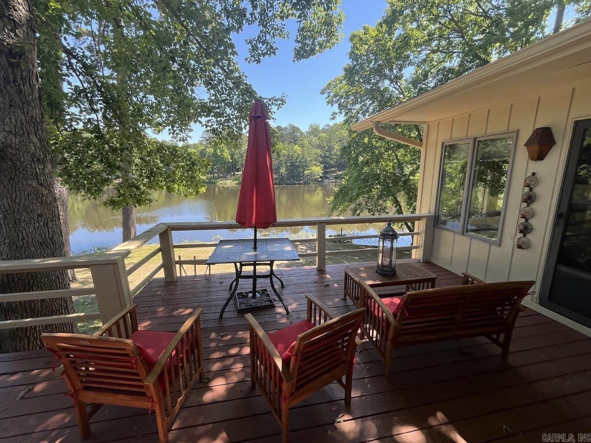 Rare gem in the Village!  Lake front home on Lake Segovia with the benefits of the townhouse association to maintain the grounds. Stunning lake view from the master bedroom, living room, kitchen, dining room and all sides of the sunroom gives this home a remote and private feel.  Take advantage of the back deck that gives you a peaceful view of the lake while you are entertaining or relaxing.  All bedrooms, both full bathrooms, kitchen and laundry are on the main level.  Seller just added a new walk-in shower that you can access from the laundry room.  Perks of the kitchen include counter space, cabinets and food pantry.  Lower level offers a bonus room/den and a hot tub in an enclosed room that overlooks the lake. Lower level has access to lake. Home has a swim dock to enjoy for fishing or swimming. You can also enjoy the cute park area with bench overlooking the lake. Updates include new roof and skylights 2024, new exterior paint and deck paint 2023, and all appliances 2 years old. Refrigerator to convey.  Sprinkler system runs off of lake and maintenance provided by townhouse association. See agent remarks.