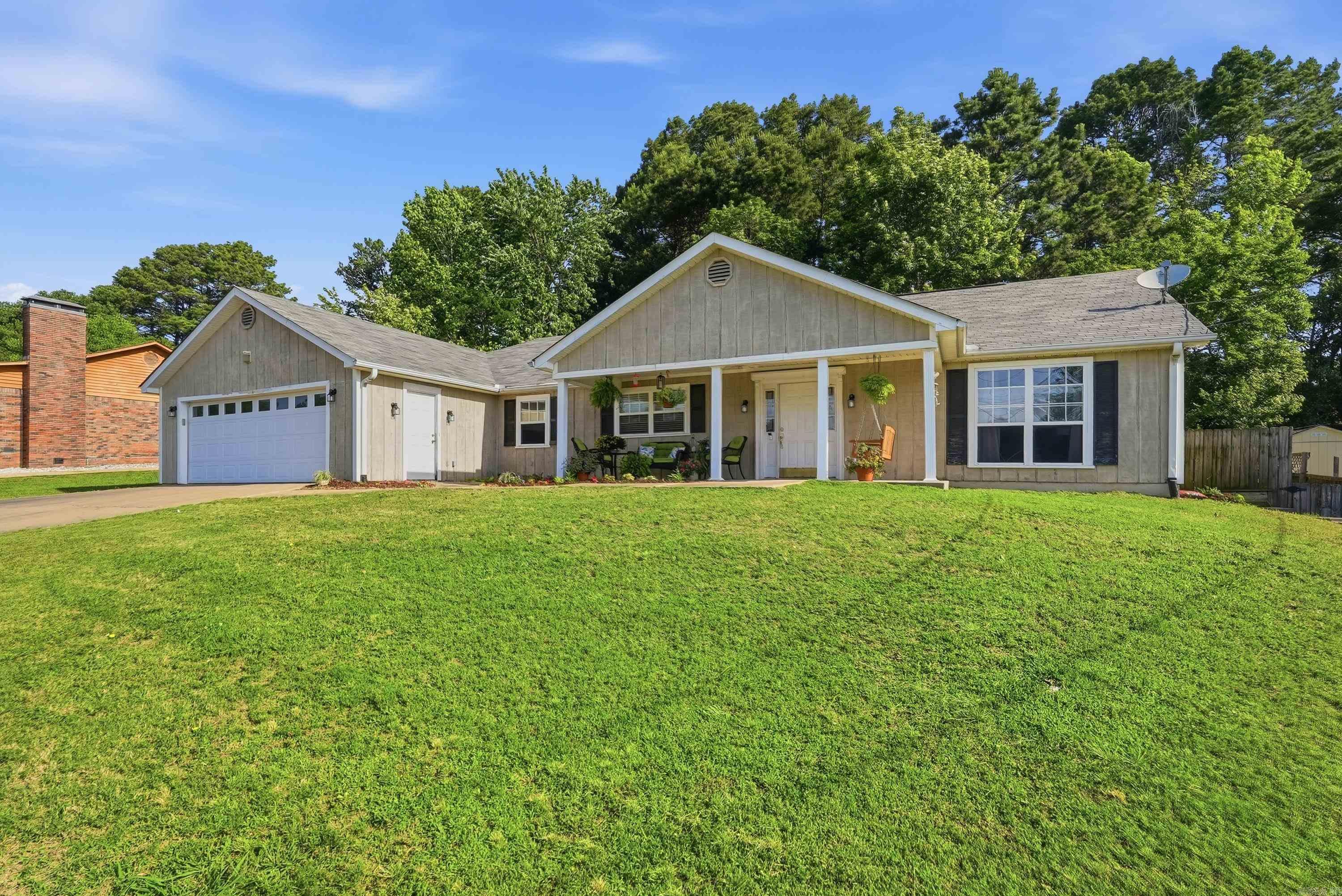 Welcome to 31 Azalea Circle! This spacious 3 bedroom, 2 bathroom home offers 2,294 square feet with a functional layout and plenty of room to spread out. Inside, you’ll find oversized bedrooms with brand new carpet, a separate dining room, and a cozy living room featuring built-ins and skylights that bring in tons of natural light. The kitchen is designed for both everyday living and entertaining with a stand-up bar, large window over the sink, coffee bar area, and not one but TWO pantries for extra storage. Both refrigerators will convey with the home! The oversized primary suite is a true retreat with separate vanities, a soaking tub, walk-in shower, and a large walk-in closet. The garage offers abundant storage space plus an additional separate storage room. Outside, you’ll also find a storage building in the backyard for even more convenience. Enjoy your mornings or evenings relaxing on the inviting front porch complete with a porch swing—perfect for slowing down and enjoying the neighborhood. If you’ve been looking for a home with generous room sizes, great storage, and thoughtful features throughout, this one is a must-see!