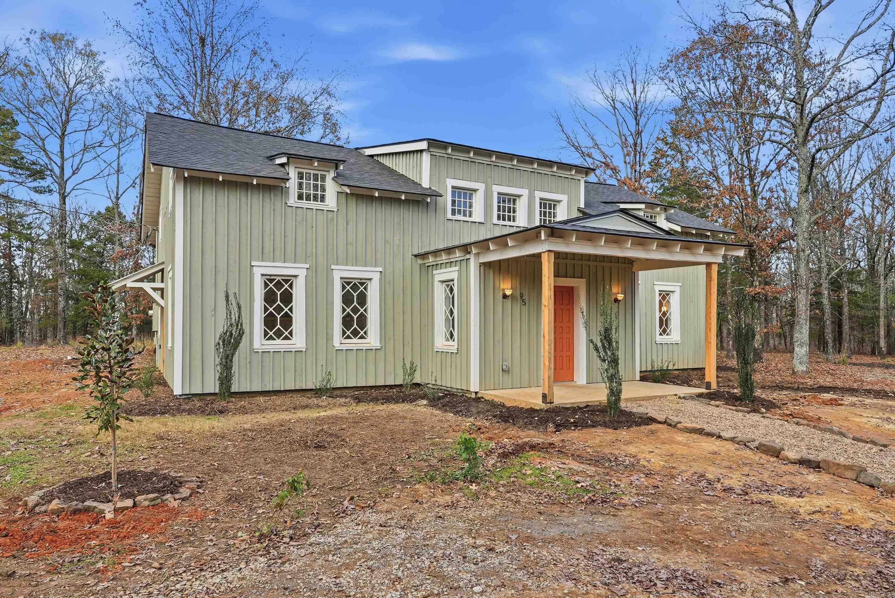 This recently remodeled home on 5 acres is one of the most unique, charming homes on the market! As soon as you enter the front porch and walk through the terracotta door, you'll know you've found something special. The charming details include 8x8 pine beams, native Arkansas pine tongue and groove floors, 100 year old windows from New England, and restored wooded doors from a turn of the century Boston tavern.  Nothing cookie-cutter here!  Downstairs you'll find a living room, large dining room, oversized pantry, beautiful kitchen with quartzite countertops and hickory cabinets , a full bath with clawfoot tub, a half bath, laundry room, and an office that could also be used as a 5th bedroom. Wainscoting walls add the perfect accent to the downstairs aesthetic. Upstairs is a large bonus room that could be used as a kid's play area, study, library, workout room, and more. All 4 bedrooms are upstairs, including an ensuite bathroom off the primary bedroom with custom tile shower. The other full bathroom also features a tile shower. This property is set up to be a homesteaders paradise with well water on site. The setting, the home, the details, are all stunning.