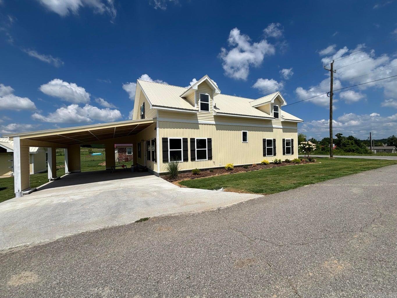 Discover the perfect blend of modern farmhouse style and small-town charm in this beautiful 3-bedroom, 2-bath home in Cave City, Arkansas. Offering approximately 2300 sq ft of living space on a desirable city lot, this move-in ready home combines comfort, functionality and exceptional curb appeal. Step inside to an inviting open-concept floor plan that's perfect for both everyday living and entertaining. The additional sunroom creates the perfect space for relaxing with your morning coffee. Outside you'll appreciate the beautifully landscaped yard and the oversized covered carport, offering convenient parking, protection from the elements and extra space for guest or outdoor activities.