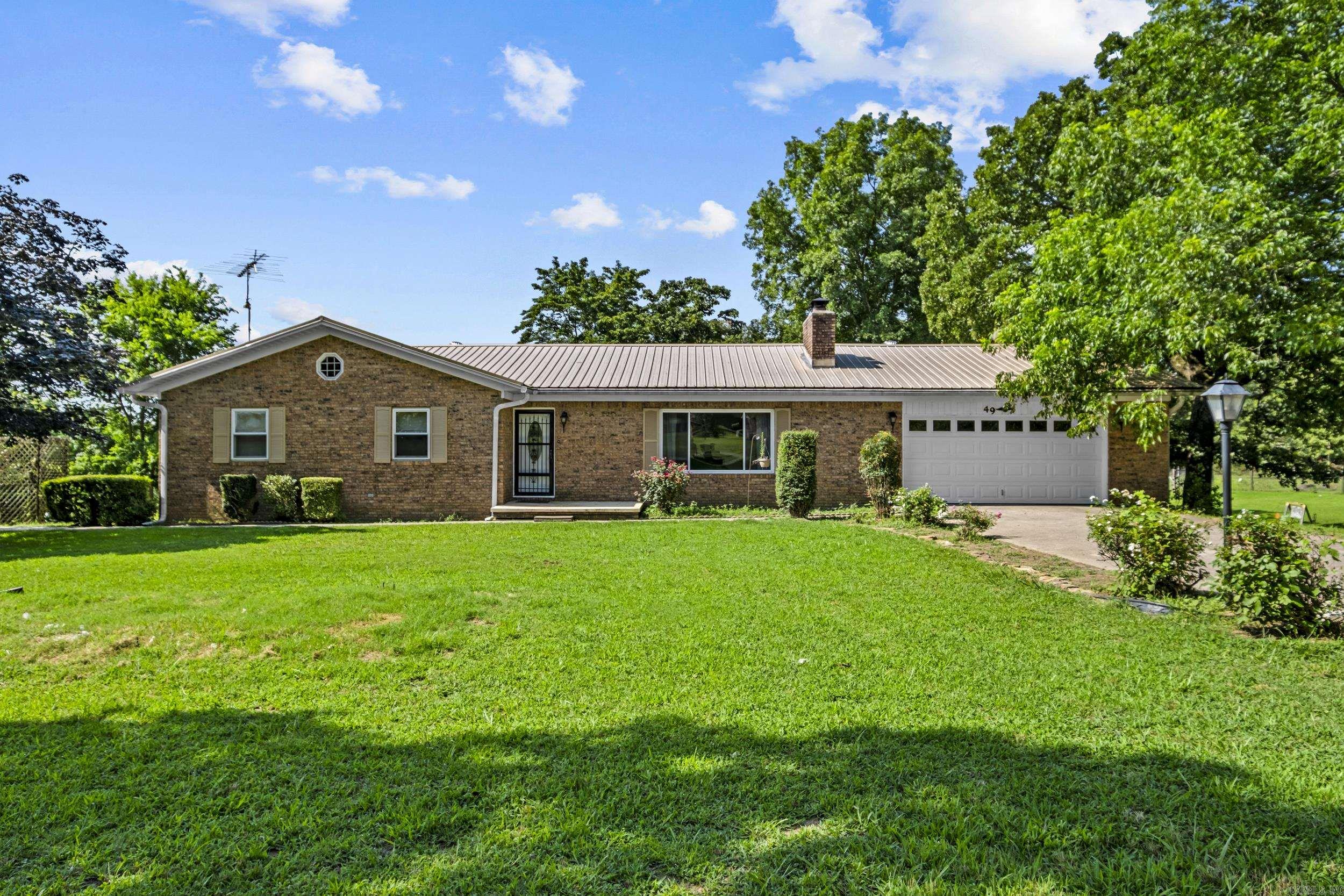 One of a kind hobby farm! Spectacular set up for a large family or someone who loves to entertain! Sitting on ten + acres, this large home has space galore with three bdrms on main level plus a finished basement. Two level home is set up with appointed rooms for all your hobbies - office space, gym area, den space, craft room, etc. Home has new doors & windows. Two HVAC systems (both new within last five years). New water heater. New French doors. Some new paint. New dishwasher. Main level features a primary suite + two more bdrms, big living area w/gas fireplace, laundry room, separate dining room, kitchen w/custom pantry & ample storage.  In the basement you'll find a second kitchen, living area w/wood insert, a den w/bar area plus two additional flex rooms perfect for office, playroom, extra storage. Garage has work bench, cabinets & shelves. Outside you'll find a 24x29 shop (new roof) w/roll up door, electricity, work table & shelves.  Deck overlooks the peaceful back yard w/creek. Small barn.  Storage bldg. Chicken coops. Pond. Fruit trees.  Raised garden beds. Two ponds.