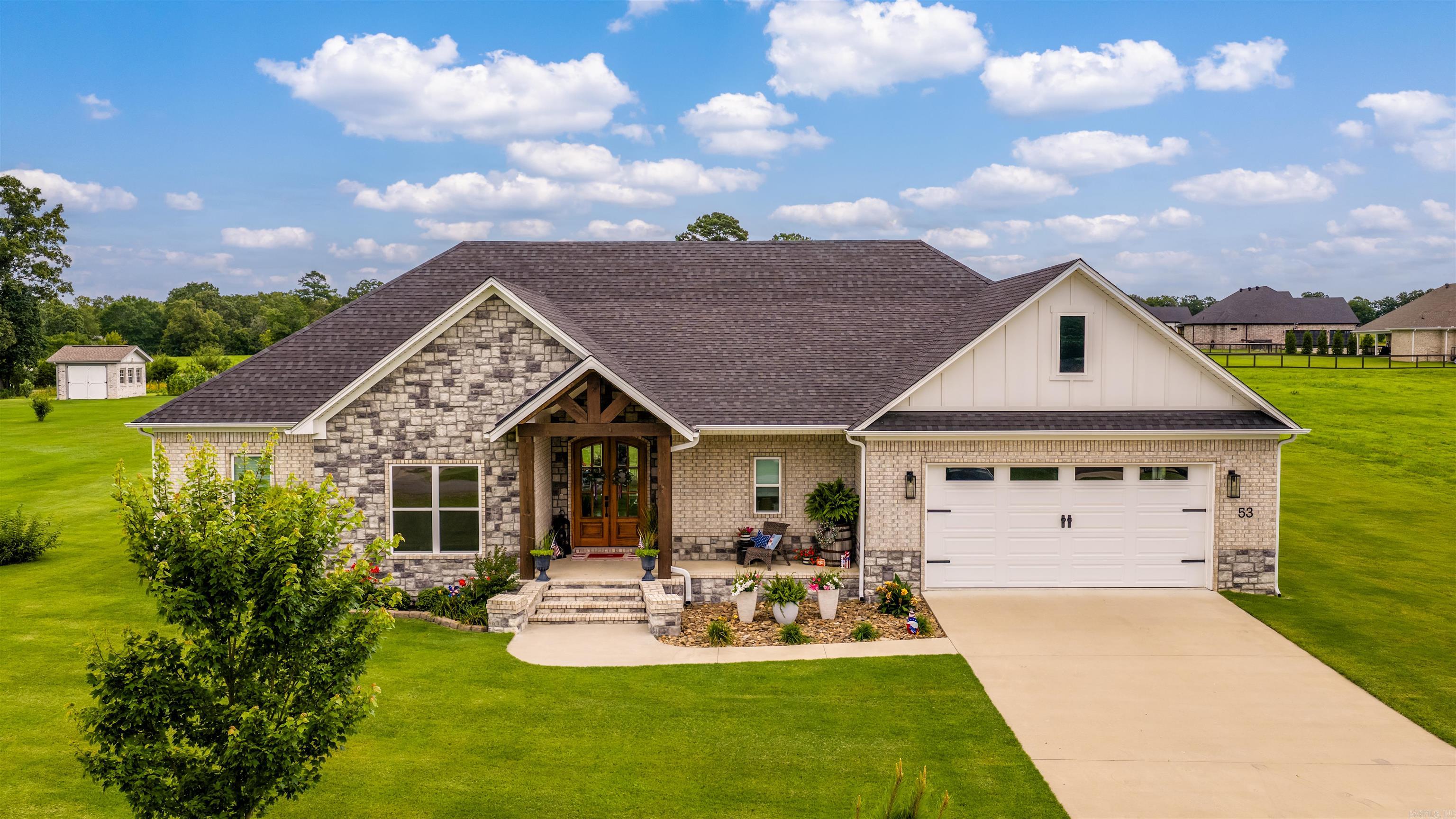 Built in 2023 and thoughtfully designed with quality finishes throughout, this stunning 4-bedroom, 2.5-bath home offers modern comfort on a beautiful one-acre lot. The open-concept floor plan features a spacious living area and a show-stopping kitchen with custom cabinetry, oversized island, granite countertops, and stylish lighting—perfect for entertaining or everyday living. The private primary suite provides a relaxing retreat, while three additional bedrooms offer plenty of space for family, guests, or a home office. Step outside to enjoy the expansive covered patio, complete with wood-accent ceilings and ample space for outdoor gatherings while overlooking the manicured grounds. A separate shop building adds exceptional versatility for hobbies, storage, or workspace needs. With attractive curb appeal, upscale finishes, and the perfect blend of indoor and outdoor living, this move-in ready home delivers the space and lifestyle you've been searching for. Don't miss the opportunity to make this exceptional property your own!