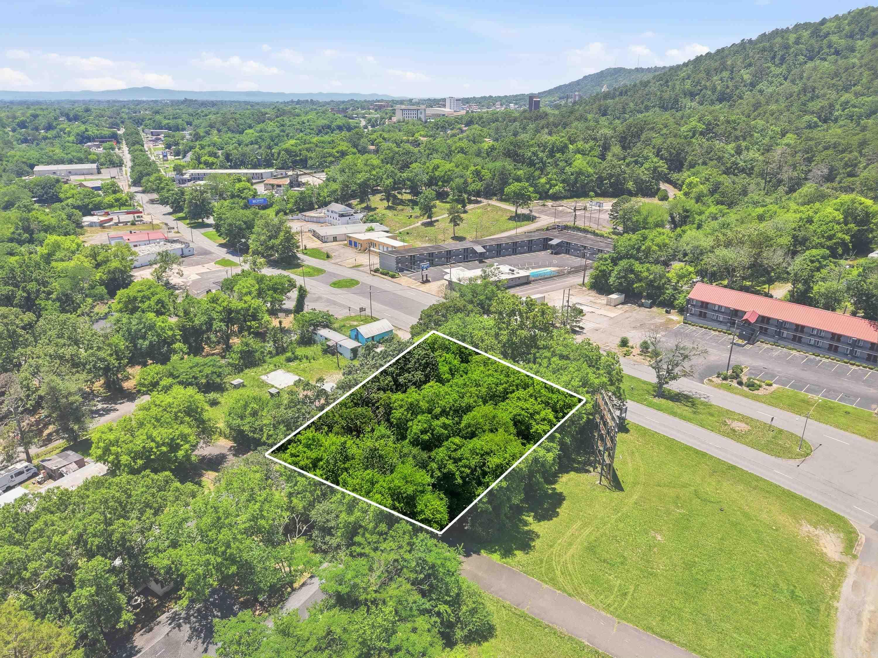Prime opportunity on one of Hot Springs' most traveled corridors! These two lots (Block 3, Lots 4 & 5, McKowns Subdivision) offer 15,376 sq ft of R-5 zoned land with high visibility frontage on Grand Avenue. R-5 zoning opens the door to multi-family development — ideal for investors or builders looking to capitalize on Hot Springs' growing demand for residential density. Situated inside the city limits with easy access to downtown, Oaklawn, and the National Park, this is the kind of in-fill location that developers watch for. Conveniently located just 30 minutes from Saline County and under an hour from Little Rock, making it an attractive option for commuters seeking affordable development opportunities. Low carrying costs at an estimated $265/year in taxes. Don't miss your chance to secure a well-positioned parcel in the heart of Hot Springs. Call today!