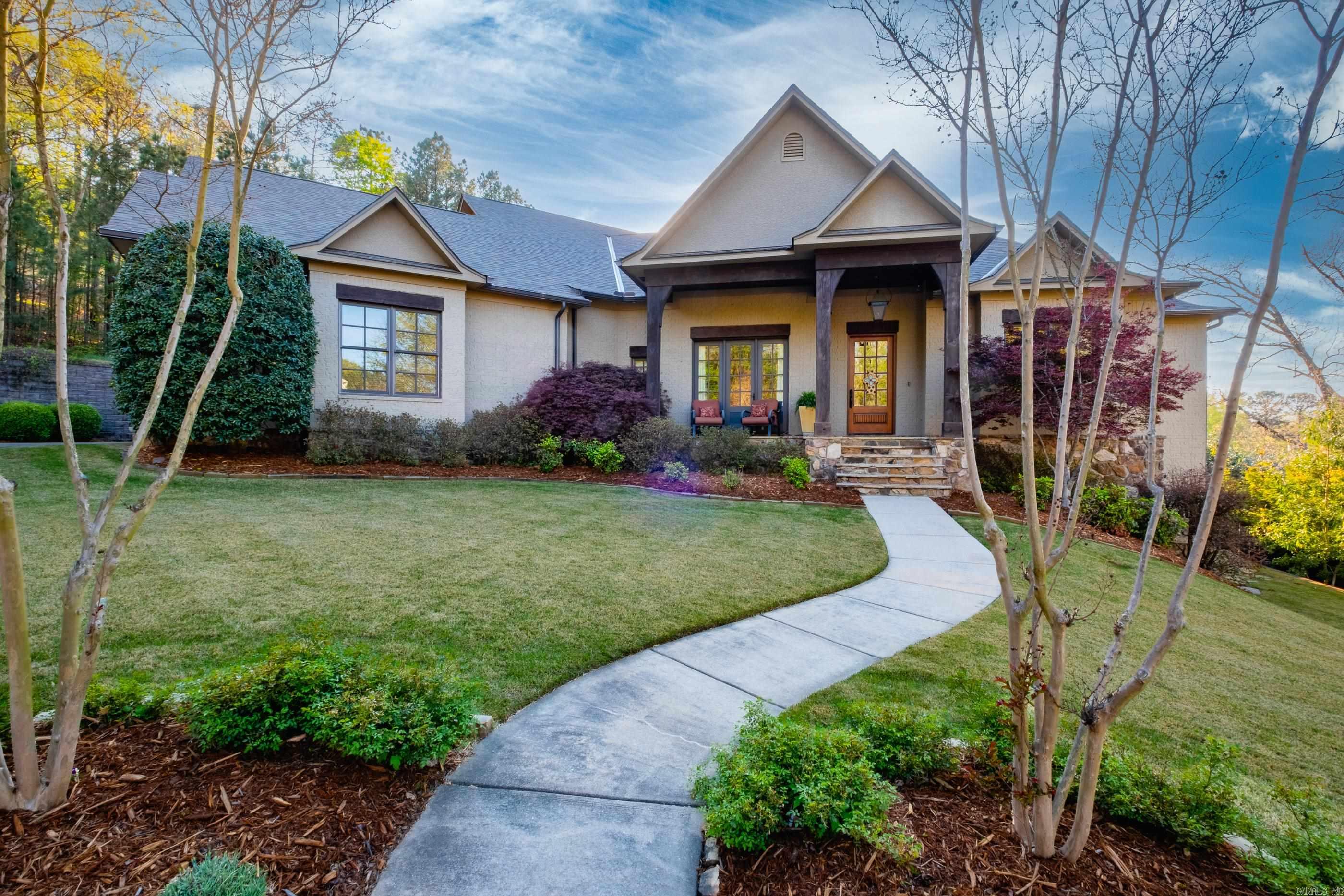 Tucked away on a private cul-de-sac in a gated West Little Rock, this exceptional residence offers refined living w/views and a resort-style pool. Perfectly positioned just minutes from premier shopping & dining.  The main level showcases an open-concept layout, where the living, dining, and gourmet kitchen flow effortlessly together.  The chef’s kitchen is thoughtfully appointed w/gas/electric range and upscale finishes.  Retreat to the luxurious primary suite featuring heated floors, a spa-inspired bath w/soaking tub, expansive walk-in tile shower, & an oversized closet designed for optimal organization. Two additional bedrooms & baths are also located on the main level.  The lower level expands the living space, a billiards area, media/TV lounge, & a versatile room perfect for a guest suite or fitness studio. A full bath provides convenient access to the pool, creating seamless indoor-outdoor living.  Step outside to the covered patio equipped w/outdoor kitchen & overlooking the private pool, an ideal setting for relaxing or entertaining.  Highlights include energy efficient geothermal system, 6”walls, whole house water filtration system, & a spacious three car garage. Come see!