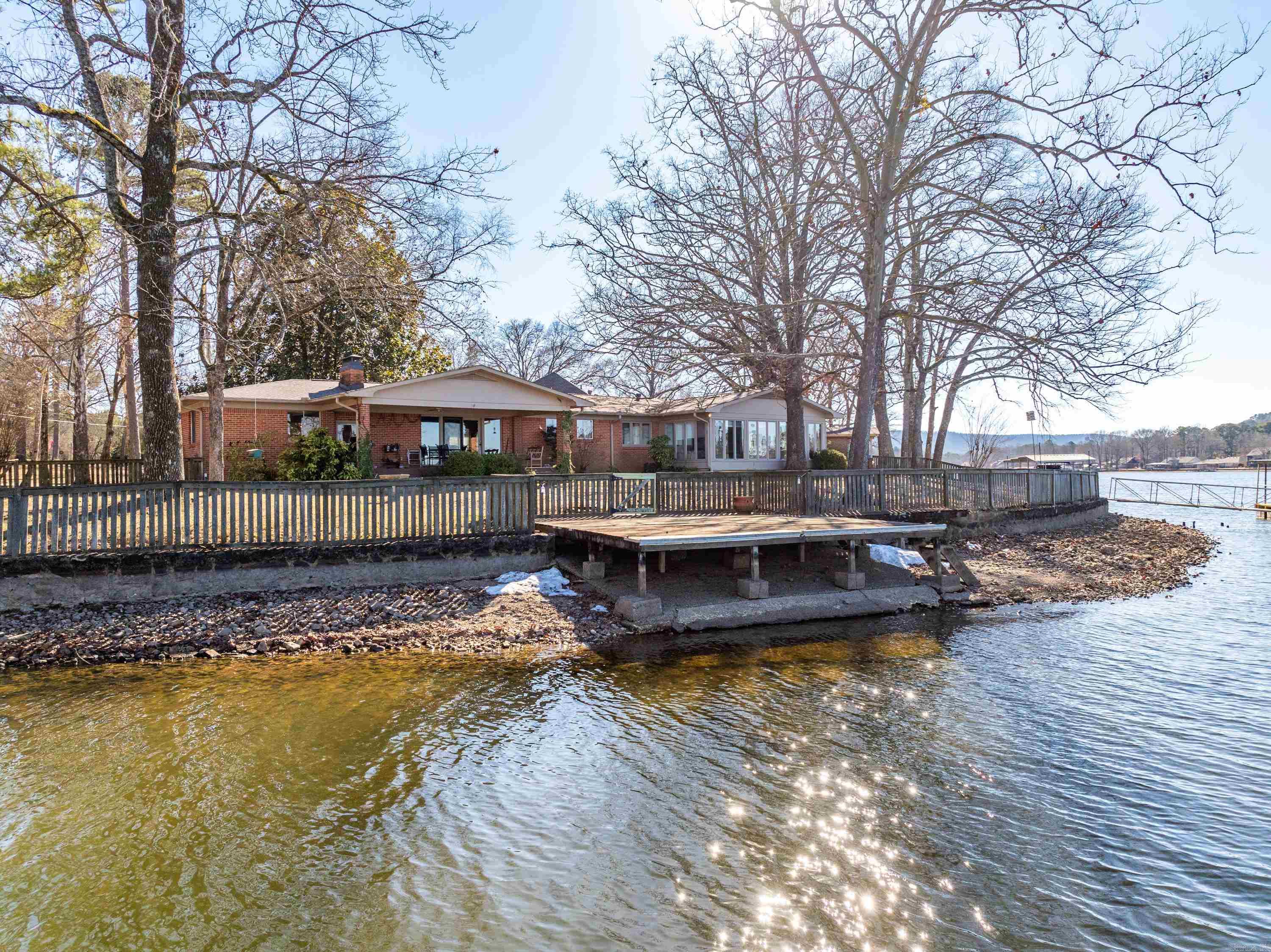 This Lakefront home at 295 Caroline Acres Road has the lake and mountain views you've been looking for.  This 4 Bedroom 3 Bath home located in the much sought after Caroline Acres subdivision is ready for its new owner.  The open floorplan features a kitchen living combination with a woodburning fireplace for those cozy nights at home.  There is a wonderful glass enclosed sunroom to spend hours gazing at the gorgeous views.  Just steps from your own private boat dock and swim dock with over 280 linear lake footage this home is the perfect place for lakefront entertaining.