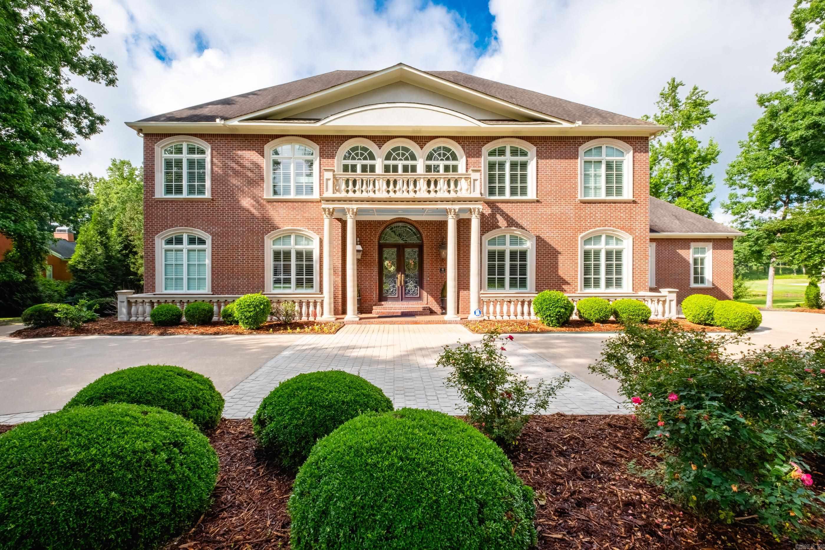 Set along Chenal Circle overlooking the golf course and pond, this stunning custom home blends timeless architecture with exceptional spaces designed for everyday living and entertaining. Grand entry with sweeping staircase opens to elegant formal living and dining areas, extensive hardwood flooring, detailed millwork, tall ceilings, French doors and rooms filled with natural light and beautiful views. Sunroom with serving bar, also creates an ideal gathering space. Gourmet kitchen with large island, premium appliances, abundant cabinetry and generous seating areas opens seamlessly into the hearth room and family living spaces. Handsome main level study with fireplace creates the perfect private retreat. Spacious primary suite features dual baths and separate closets. Main level guest suite offers flexibility for guests or multi generational living. Upstairs includes four additional bedrooms, baths and game/play/bonus spaces. Exceptional storage areas on both the main level and upstairs provide added functionality. Outdoor living is designed for entertaining with covered patios, outdoor kitchen, pool and expansive gathering areas overlooking the golf course and pond. Come see!