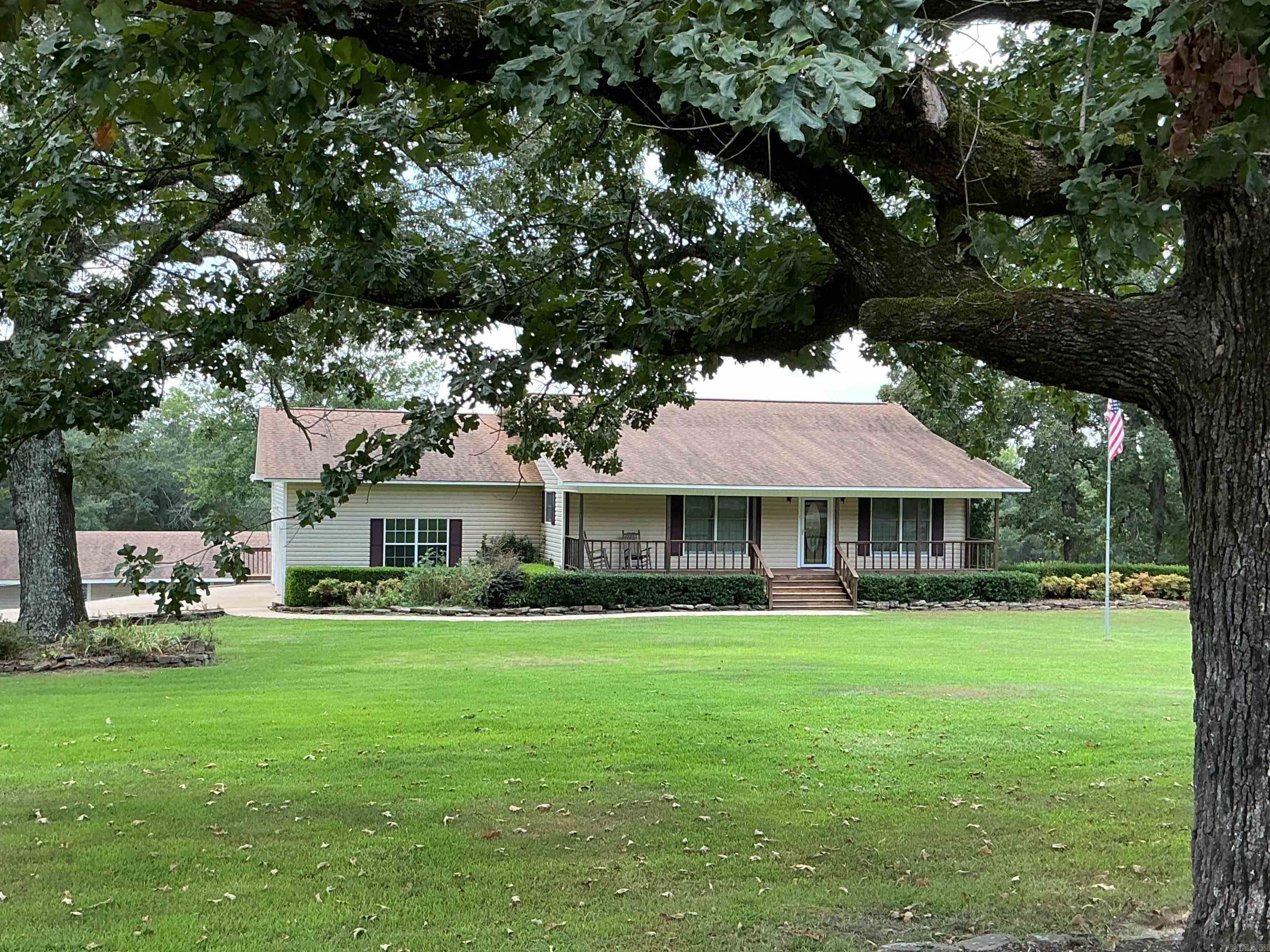Beautiful Lakefront Country Home with Boat slip on 2.43 acres Wow this place has so much to offer with plenty of room outside and inside! Home is 3 beds, 3 baths, spacious rooms, lots of windows in open Kitchen, dining, living room with corner gas log Oak fireplace and Tray ceiling, walk out to 16 x 28 covered deck.  Full finished basement with lots of storage and sleeping areas. 2 baths up and 1 down. New Roof and Heat and air replaced in 2018 and has a dehumidifier built in. New floors in basement and new paint all through home, Stairlift was replaced with new one last year. Central Vac system throughout! Outside has attached 2 car garage, shop building with rollup door, electric, water, old bathroom, plenty of storage and lean-to on side. 2 carports for camper, boats or vehicles. 1 Boat slip in a 5 stall boat dock. Gentle walk to the water.
