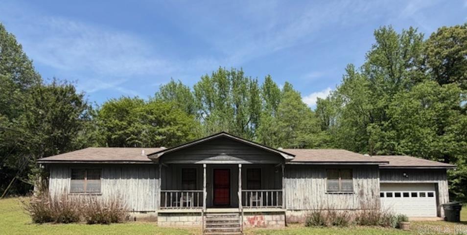This Charming country one owner home sits on a 1.5 acre lot.  This 3 bedroom 2 bath home offers the perfect blend of space, comfort, and rustic charm.  Step into this open layout featuring wood floors throughout. A Spacious kitchen with ample counter space flows seamlessly into the large dining area.  A great layout of 1800 square feet make this home feel larger and open. Oversized garage with workbench and storage space.  For Sale "AS IS"