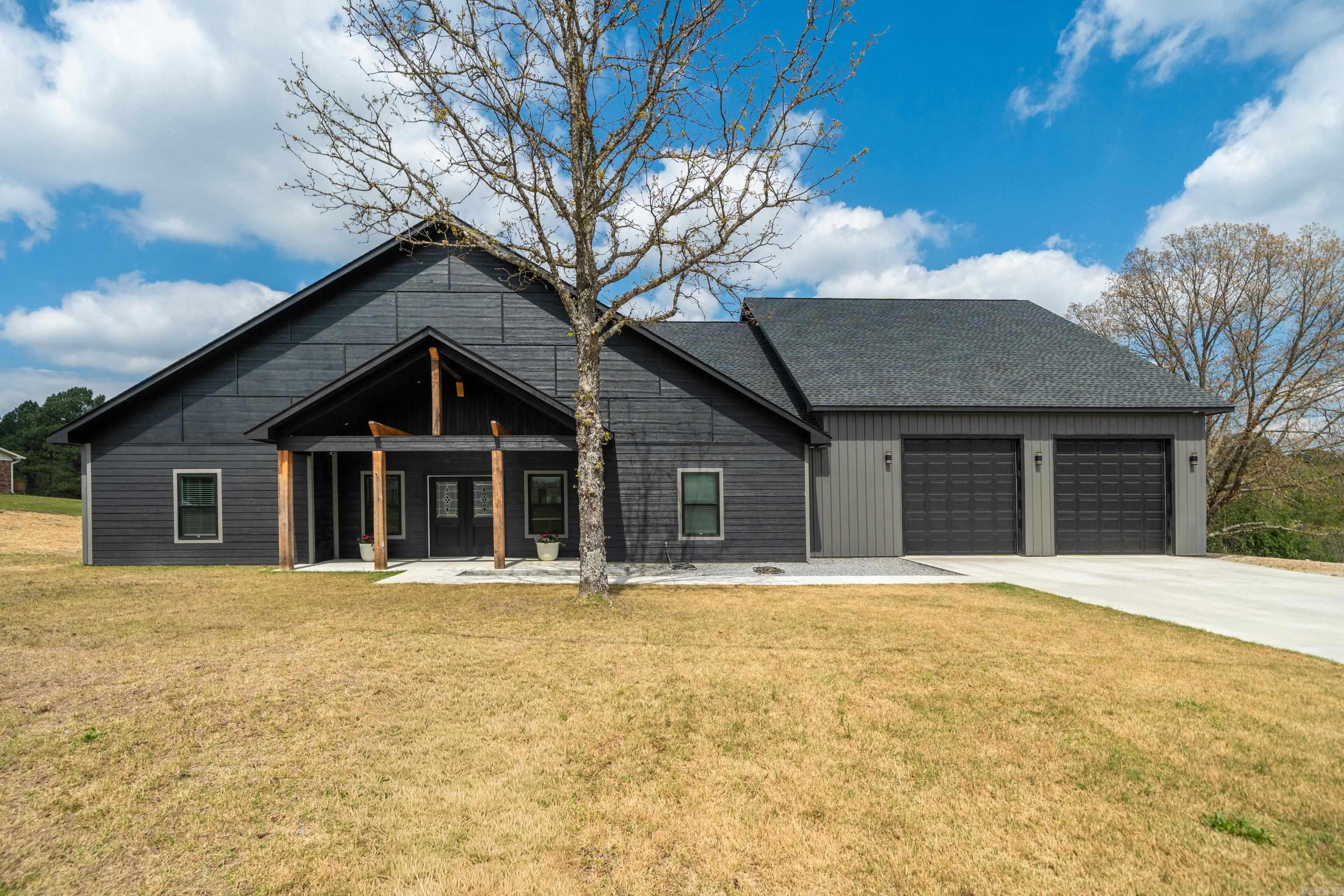 Stunning modern farmhouse on over an acre in the highly sought-after Lake Hamilton School District. This 3 bedroom, 3.5 bath home is packed with features you don’t want to miss—an outdoor kitchen perfect for entertaining, a versatile multifunctional room, and a fully finished space off the garage ideal for a home gym or bonus room. High end finishes such as quartz countertops, vaulted ceilings, large bedrooms, butlers pantry. This home also has 2 HVAC units. Plus, enjoy peace of mind with a Generac generator and oversized 10-foot garage doors for all your storage needs. Modern style, functional space, and room to breathe—this one truly has it all.