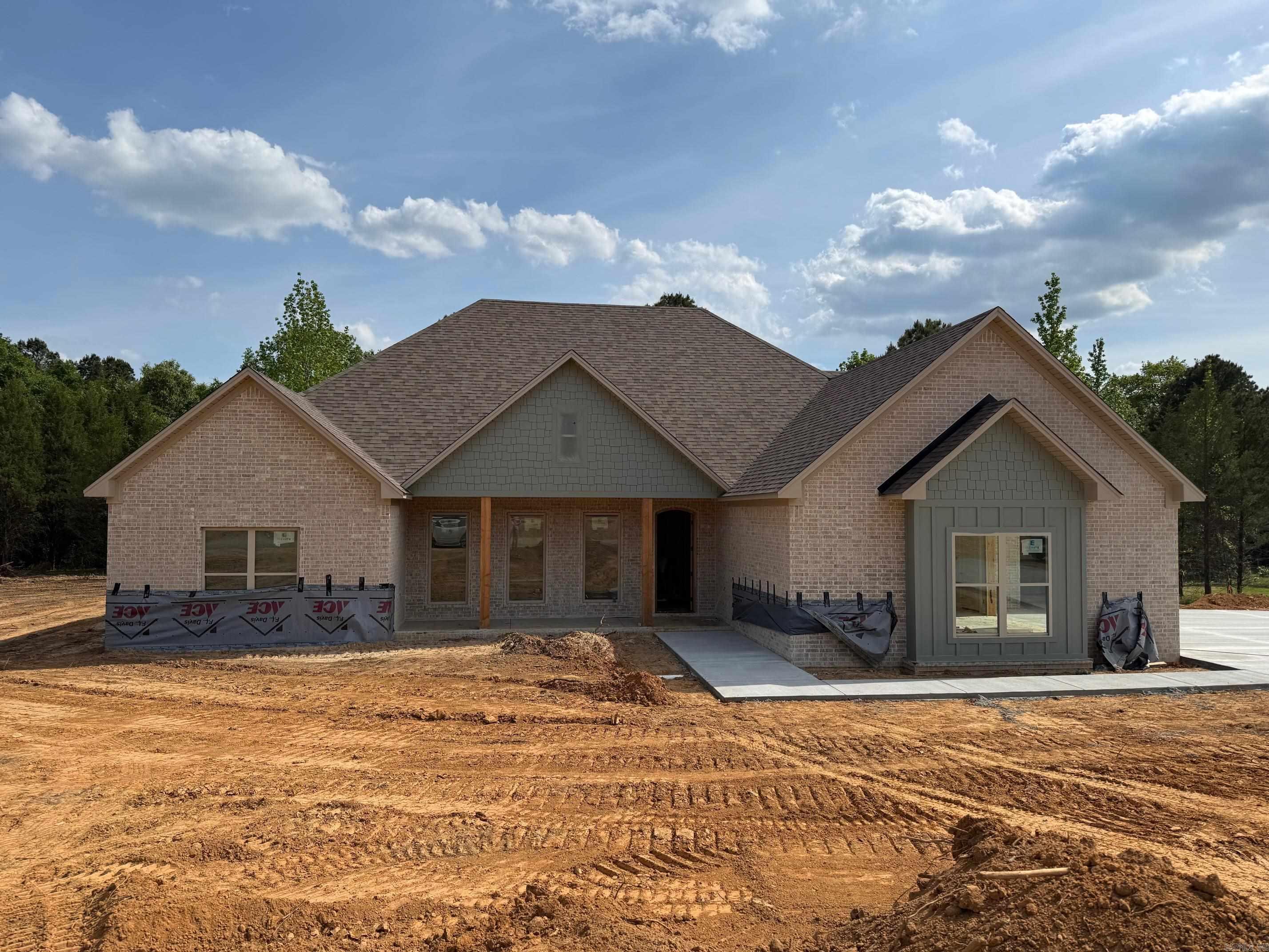 Welcome to this beautiful new construction home set on a spacious 1-acre lot. This thoughtfully designed 4-bedroom, 2.5-bath home features an inviting open-concept layout perfect for both everyday living and entertaining. The living area flows seamlessly into a stunning kitchen with custom cabinetry, a large island, and plenty of workspace. Enjoy natural light throughout, highlighted by expansive sliding glass doors leading to a covered back porch—ideal for relaxing or hosting guests.  The exterior showcases a timeless blend of brick and modern accents, complemented by a welcoming front porch. Inside, you’ll find quality craftsmanship, stylish finishes, and a functional split-bedroom floor plan offering privacy and comfort. The generous lot provides ample space for outdoor activities, future additions, or simply enjoying the peaceful surroundings.  Don’t miss the opportunity to own this brand-new home with modern design and room to grow!