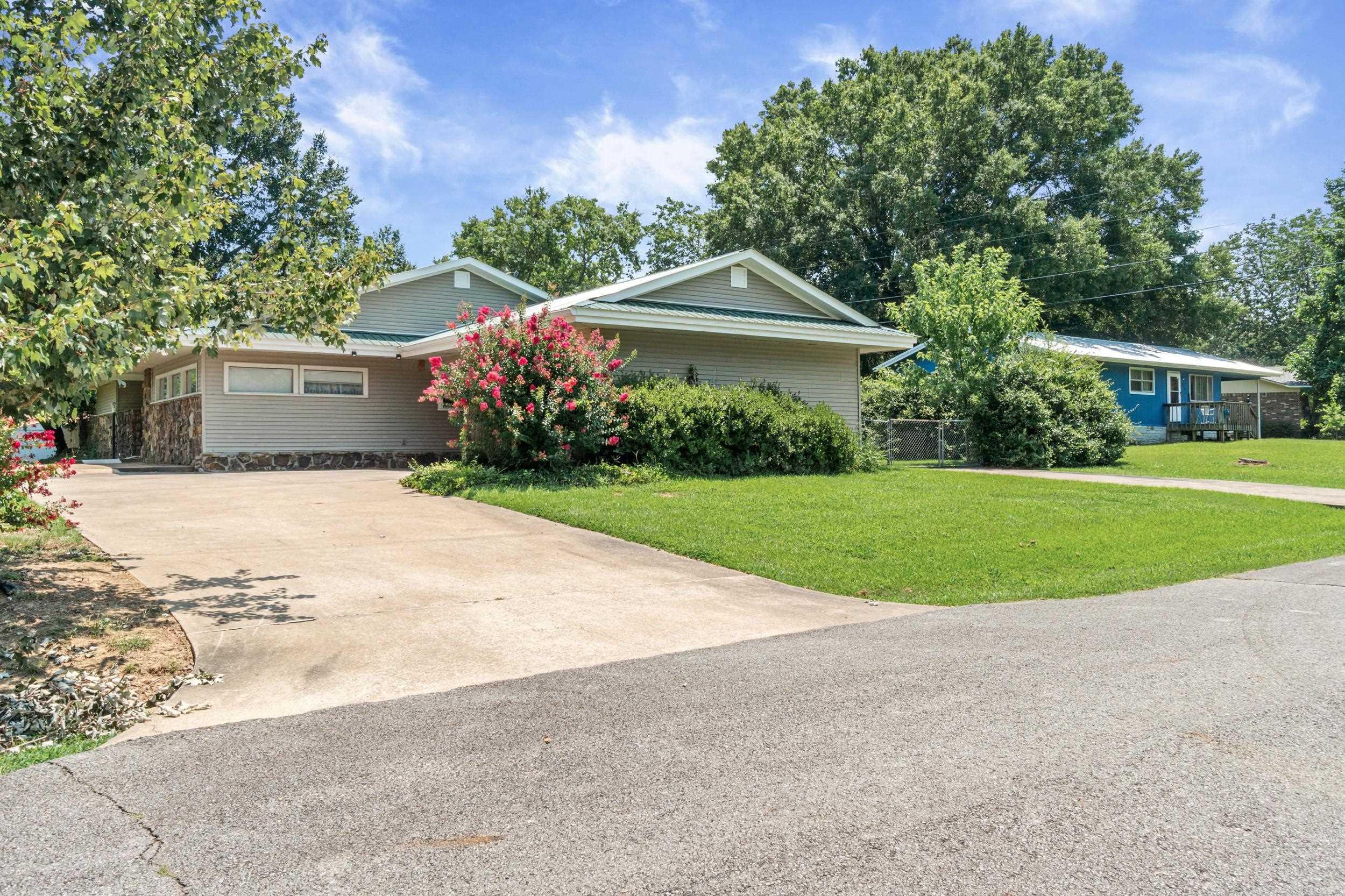 Beautifully maintained home in the desirable Crappie Cove Subdivision. This thoughtfully designed home features two spacious living areas centered around a stunning atrium, creating a bright and inviting focal point visible from the living room, dining area, and kitchen. The open kitchen and dining area overlook the atrium and offer direct access to a covered patio, perfect for enjoying your morning coffee while taking in the peaceful surroundings. The sunken living room features a floor-to-ceiling stone fireplace, converted to electric for year-round ambiance. The second living area provides endless flexibility for a family room, media room, or home office. Offering three spacious bedrooms, the primary suite and one secondary bedroom each have private access to a secluded patio. Recent updates include a newer roof with an improved roofline, updated windows, sliding glass doors, & a 250 AMP electrical upgrade. Enjoy multiple outdoor living spaces, a tranquil garden setting, and a peekaboo view of beautiful Greers Ferry Lake. Meticulously maintained with numerous upgrades, this unique home combines timeless character, thoughtful design, and exceptional pride of ownership.