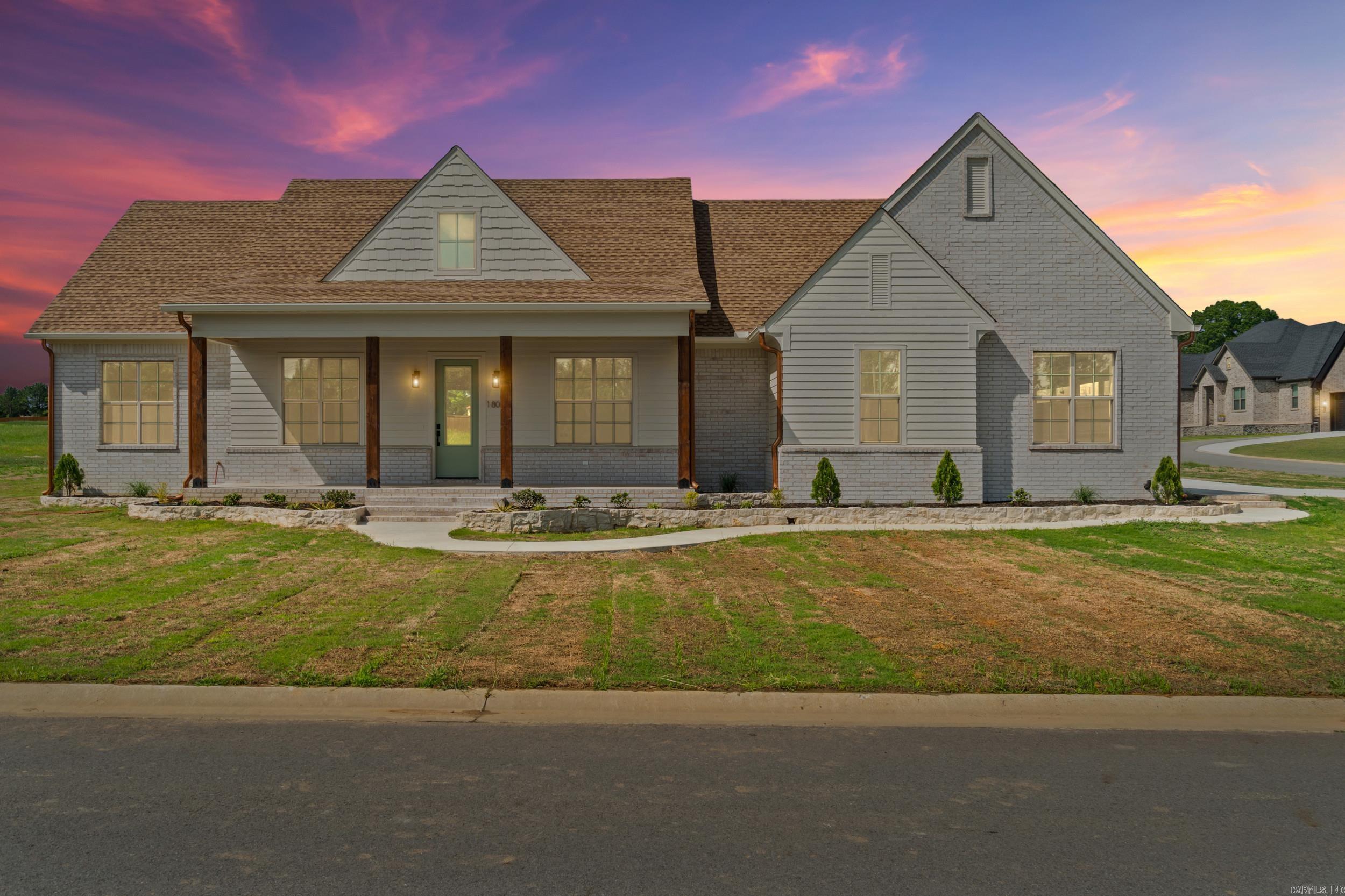 Beautiful new construction home in Belmont Estates with thoughtful design and high end features.  This home features four spacious bedrooms, two and a half baths and offers soaring ceilings, lots of light, and a fabulous brick fireplace as the focal point of the open living area. The kitchen is designed with a large island, breakfast bar seating and a Pinterest worthy hidden pantry.  A separate dining room or office provides flexible space.  Lockers, a spacious laundry room with added storage and an elegant half bath add charm to the back entry off the garage.  The back porch is spacious and features a charming wood ceiling.