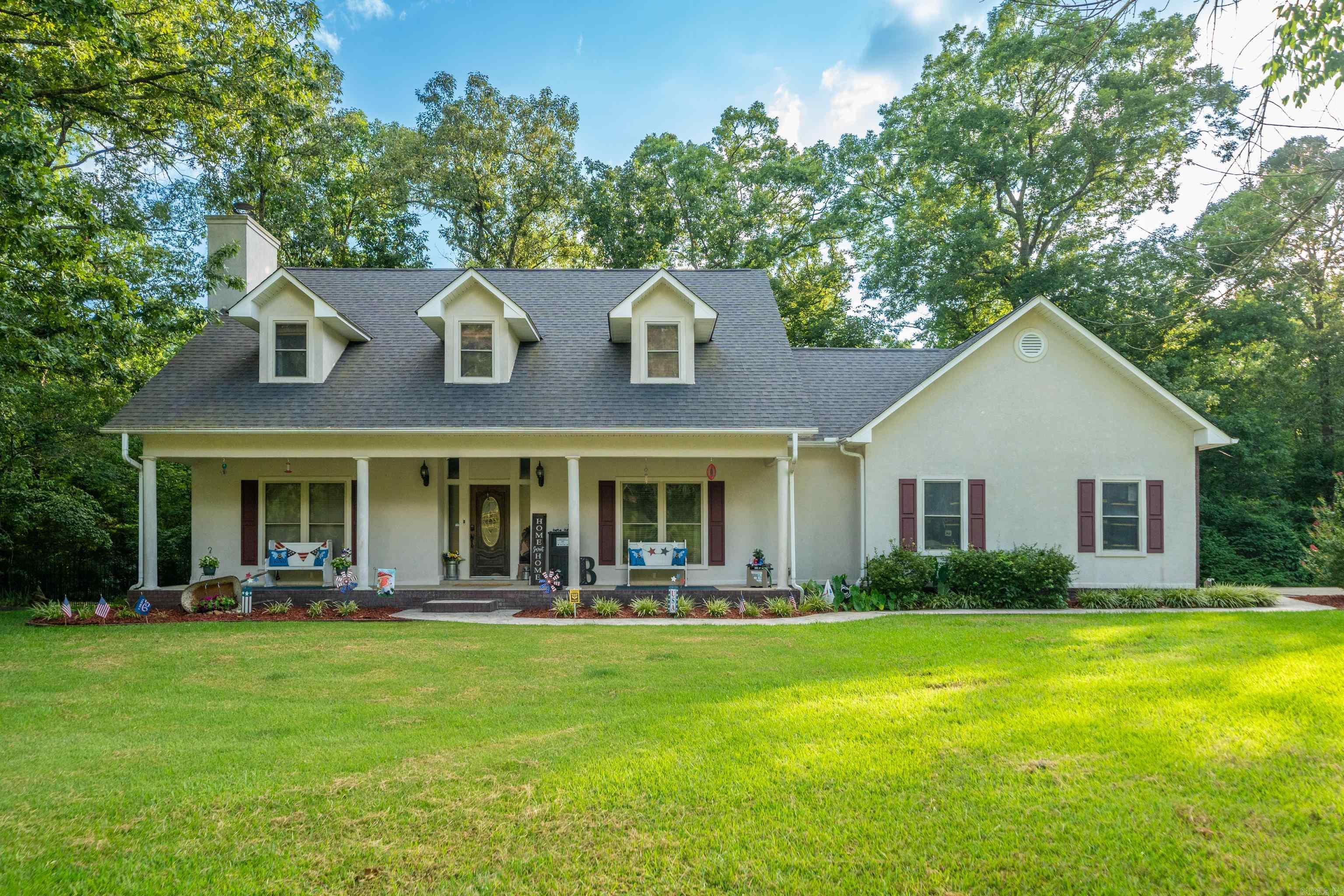 Welcome home to this stunning 5-bedroom, 2.5 bath property nestled on 2.06 beautiful acres in Fountain Lake School District. Surrounded by mature trees in a peaceful, quiet neighborhood, this property offers the perfect balance of privacy, comfort, and convenience. From the moment you arrive, you'll appreciate the inviting curb appeal and spacious front porch that welcomes you inside. Split floor plan boasts an open living room with a wood burning fireplace, gleaming hardwood floors & brand new carpet. Beautifully renovated kitchen with abundant cabinetry, updated finishes, and a large walk-in pantry that provides exceptional storage. Main level features a flexible bedroom that can easily serve as an office, along with a half bath. Upstairs, the spacious primary suite offers a relaxing retreat with a large walk-in closet and a laundry chute for added convenience, his & her vanities & a walk in shower.  Three more bedrooms & bath upstairs. Relax on the oversized back deck overlooking your own slice of paradise. Follow the property to the year-round creek & enjoy the peaceful setting. A detached shop adds more versatility for hobbies, storage and workspace. See agent remarks!