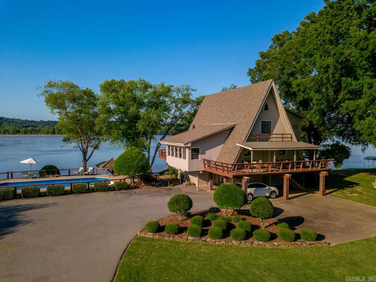 Spectacular custom built home on the bank of the Arkansas River. Situated on approx. three beautiful level acres with direct river access. Enjoy the amazing views and relaxing atmosphere year round! Open living design with inviting decor' Handsome hardwoods and custom mill work. Gourmet kitchen and large dining room. Office, Upper level terrace with panoramic views.  In-ground pool, Gazebo and deck for the ultimate in outdoor living and entertaining. Boat slip, storage room. A very special home or exceptional retreat. A must see!