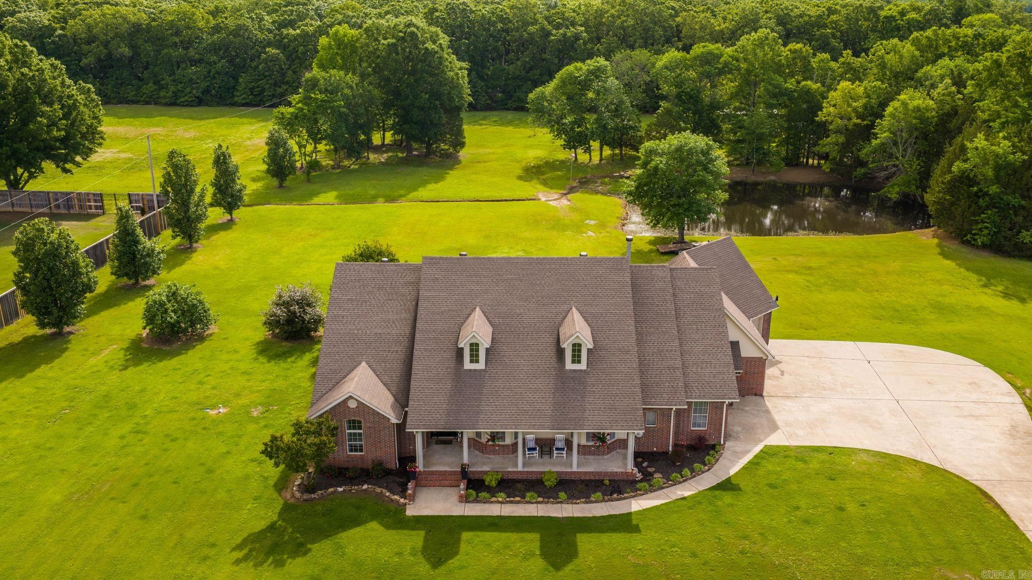 WANT IT ALL IN CONWAY?  Large Home with 3-Car Garage and Safe Room, almost 5 Acres, Stocked Fishing Pond and a 30x40 Shop, just outside of Conway City Limits. This home has it all. This home features 4 bedrooms and 3 bathrooms, plus an office and 2 living areas downstairs and a large game room/5th Bedroom upstairs. Built for efficiency and strength with 2x6 exterior walls and insulation in the exterior and interior walls. The expansive back porch is covered with a vented grill area and TV that overlooked the massive back yard and pond that is stocked with fish.  The roof and both A/C Units have been replaced in the last 5 years and there's nearly enough concrete on the driveway to land a plane. There is storage space for all your toys, room for the family and a porch and yard for all your friends.  Don't miss this one!