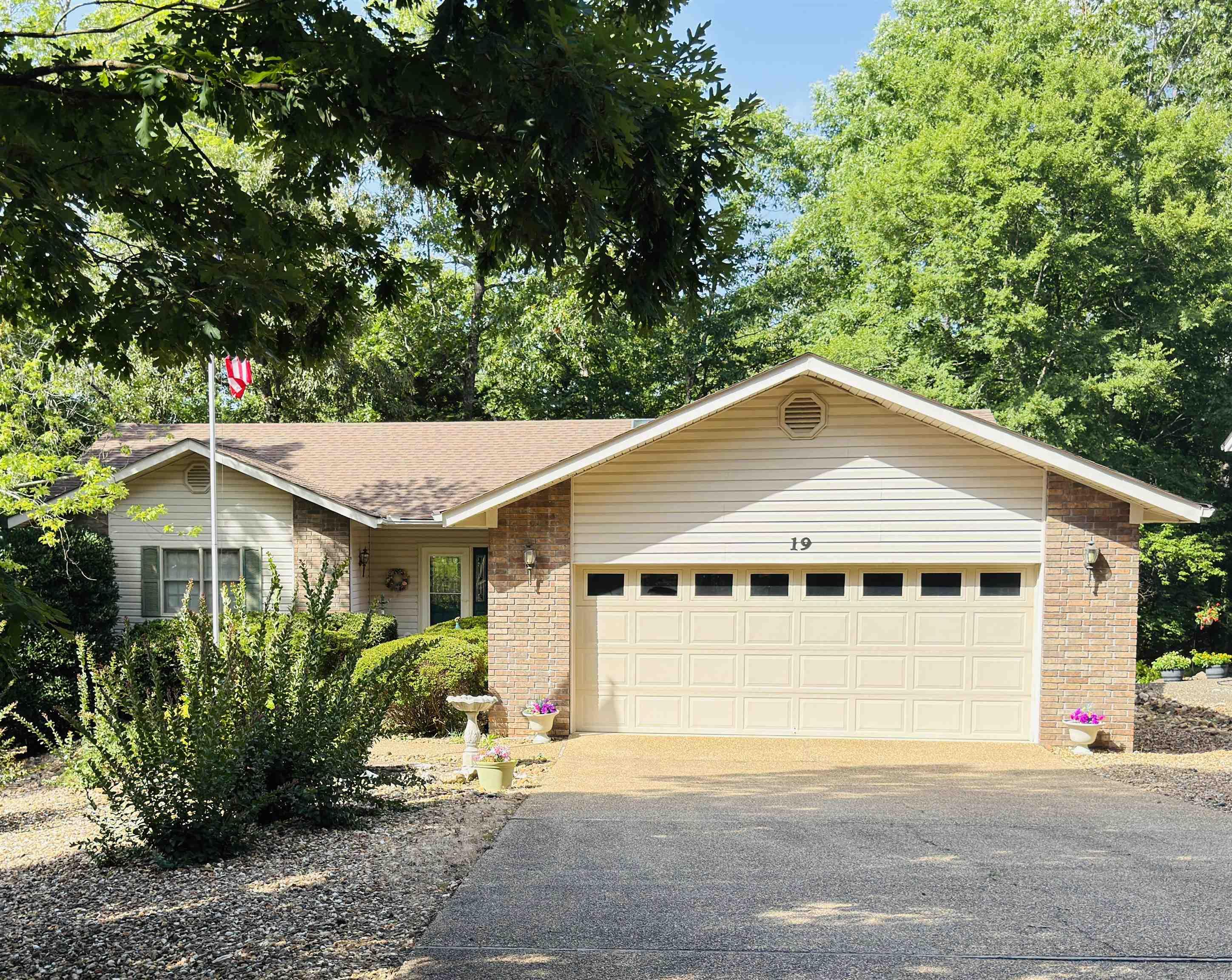Welcome to this beautifully maintained, single-level home nestled on a quiet cul-de-sac in the sought-after Lake Coronado neighborhood of Hot Springs Village. Step inside to an open living space with vaulted ceilings and peaceful wooded views that create an immediate sense of calm and relaxation. The thoughtful split-bedroom floor plan gives everyone their own space: a generous primary suite with en-suite bath and walk-in closet on one side, and two spacious guest bedrooms sharing a full bath on the other. The updated kitchen offers abundant cabinetry, generous counter space, a convenient breakfast bar, and modern appliances. Outside, enjoy the well-maintained deck and charming screened porch overlooking a beautiful, private backyard. Additional highlights include a newer roof installed in 2022, a level driveway, ample crawl space storage, and the kind of wonderful neighbors that make a house feel like home.  This lovingly cared-for property delivers the comfort, privacy, and relaxed lifestyle Hot Springs Village is famous for.