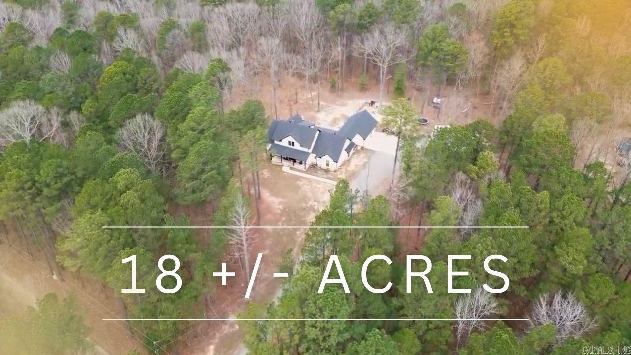 Price Improvement! Easy To Show. The Ultimate Private Escape at 631 Zoa Way! An exceptional 18 acre retreat positioned near Little Rock and Bryant. From the sprawling covered front porch, pass through the double-door entry to an expansive open floor plan anchored by polished concrete floors. Large windows frame the wooded backyard. The main level has 4 bedrooms and 3 full baths, while the upstairs bonus room provides the perfect flex space with a half bath. At the heart of the home sits a chef's kitchen connecting two dining spaces and walk-in pantry. Indulge in a spa-inspired primary wing, anchored by a freestanding soaking tub and glass enclosed double shower. The footprint is completed by expansive vanities and walk-in closet. Warm up by the indoor stone fireplace or head to the covered back porch to enjoy the outdoor fireplace and hot tub. The 3 car garage and 30x40 workshop complete the home. Unlock the full potential of country living with this versatile 18-acre estate. Featuring a ready-to-use livestock pen and space for all your entertaining and agricultural goals, it’s the perfect canvas for your vision. Schedule your private showing! VIDEO TOUR AVAILABLE.