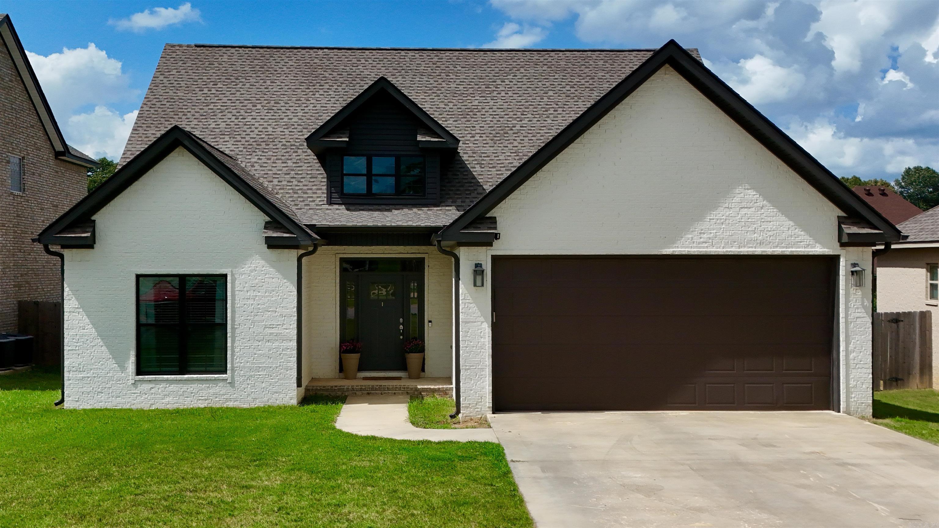Distinctive design and custom finishes set this 4-bedroom, 3-bath home apart. Offering 2,175 sq. ft. in the Nettleton School District, this thoughtfully designed floor plan features acid-stained concrete flooring throughout the main level, raised ceilings, and a striking living room with electric fireplace and dramatic accent wall. The eat-in kitchen offers breakfast bar seating, solid surface countertops, abundant cabinetry, and a full appliance package. The spacious primary suite includes tray ceilings, walk-in closet, dual vanities, and an oversized custom glass shower with built-in bench. Two additional bedrooms and a full bath are located on the main level. Upstairs you'll find a private fourth bedroom, full bath, and bonus landing ideal for a home office, study area, or reading nook. Additional features include a large laundry room with storage, double garage, privacy-fenced backyard, and .22-acre lot. Conveniently located near shopping, dining, and everyday amenities.
