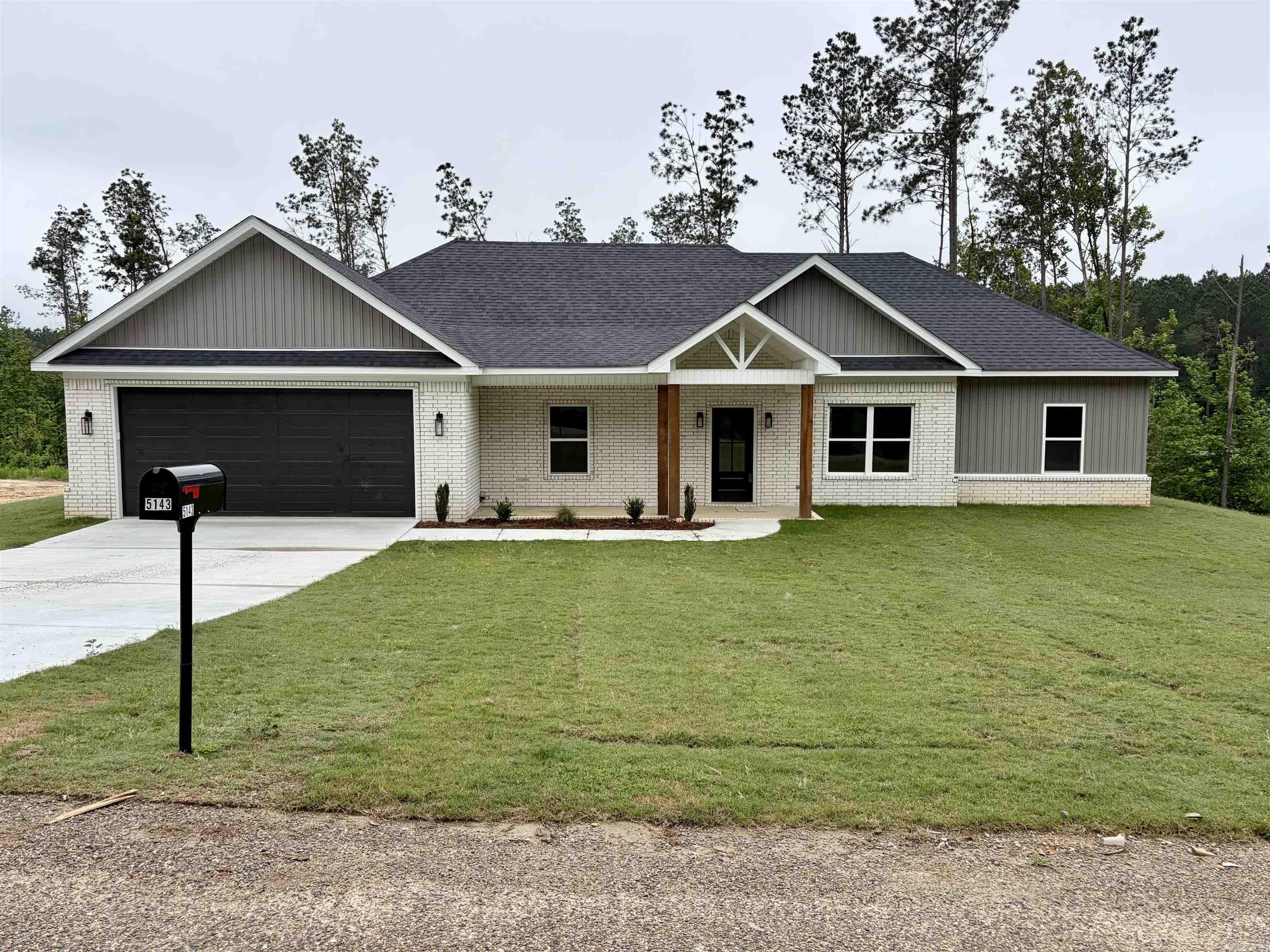 This new construction all electric home offers approximately 1650 square feet of comfortable living space in a country subdivision on a little over 3 acres.  Featuring an attractive brick and vinyl exterior, this property offers the perfect blend of privacy, space and modern comfort.  Step inside to a spacious, open den/kitchen designed for gathering, complete with gorgeous quartz countertops, a large island with matching quartz surface, and plenty of room to cook, entertain and enjoy everyday living.  Storage is abundant throughout the home, with built-in features in all closets to help keep everything organized.  The oversized primary suite provides a relaxing retreat with a spacious bedroom, large bathroom featuring a soaking tub, walk-in shower, and generous walk-in closet.  The laundry room offers exceptional storage with two closets and laundry sink.  Enjoy peaceful morning and relaxing evenings on the covered back patio overlooking your acreage.  If you are looking for country charm with modern features and room to spread out, this one is a must-see.  (Taxes are based on lot price - not house.)