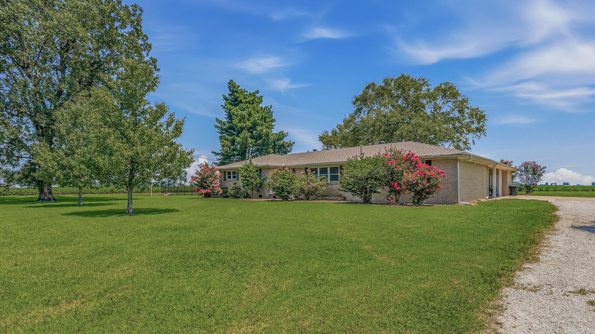 Spacious 3-bedroom 3 bath home offering 3063' of well-designed living space. This beautiful property features 2 living areas, a bright sunroom looking out into the garden area, and a large primary suite with a Jacuzzi tub, walk in shower and ample closet space. The kitchen and living areas provide plenty of room for everyday living and entertaining. Outside, enjoy a beautiful, landscaped yard with mature shade trees, a water feature, and black metal decorative fence. Additional amenities include a 3-car attached carport with 2 large storage rooms.