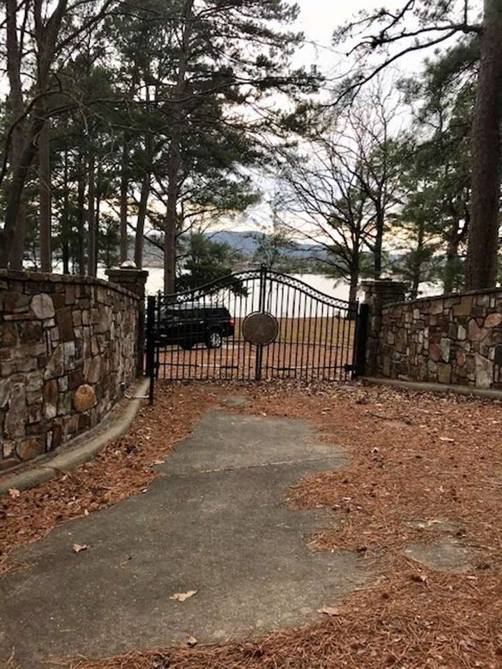 Rare find on Lake Hamilton!  Gated entrance into the property - 7 south location. Tri-Level home with 250' on the lake and double covered boat dock. One of the most premier properties on Lake Hamilton. Phenomenal views!  This 250 feet of Lake Hamilton Lakefront Property is within the Planning Area of the City of Hot Springs.  Sellers are in the process of proceeding with application to move a lot line on the property to divide it into 2 awesome Lake Lots!