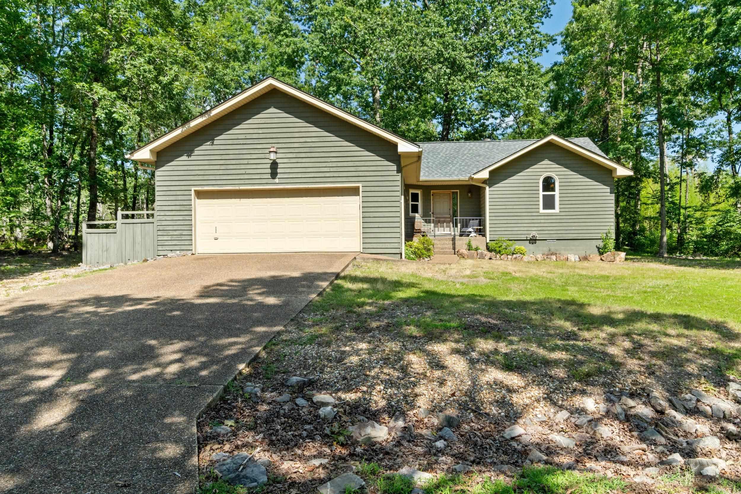 INCREDIBLE opportunity to purchase this home with a 2.25% assumable interest rate! This charming home showcases a rustic interior that perfectly embodies the Arkansan lifestyle. With 3 bedrooms, 2 bathrooms, and a generous additional room ideal for a den or extra bedroom, it offers both comfort and versatility. Step outside to a spacious back deck, all nestled in a peaceful, wooded neighborhood in beautiful Hot Springs Village, surrounded by 9 golf courses and 11 pristine lakes. Enjoy the perfect blend of privacy and natural beauty and schedule your showing today!