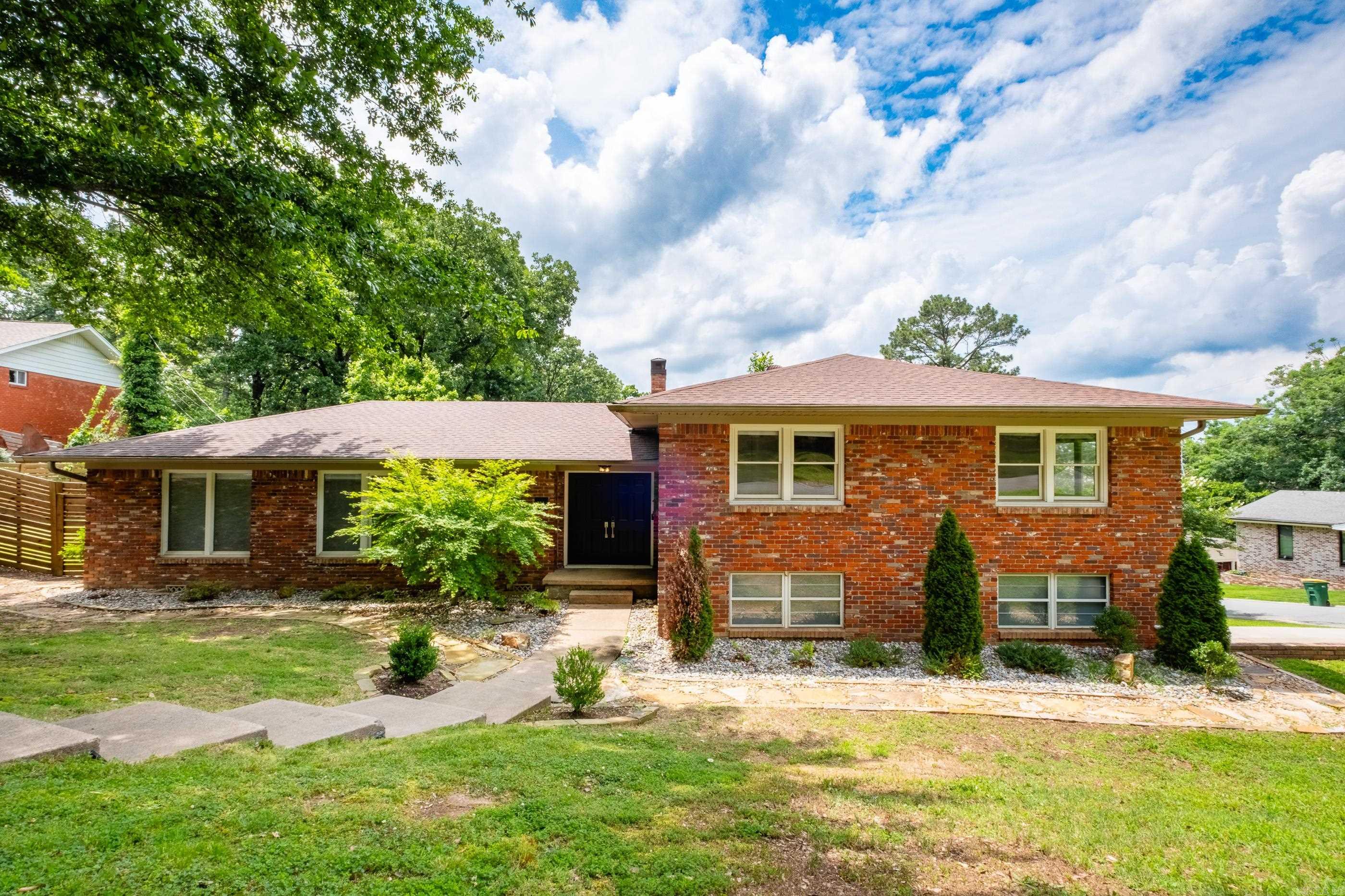 This conveniently located and impeccably maintained home offers a wealth of charm and character, along with significant living space. The property features five bedrooms, three full baths, and three distinct living areas. Notable interior details include two fireplaces, built-in shelving, and beautiful original hardwood floors. The home is filled with natural light and includes French doors that lead to a fully fenced backyard. For outdoor entertaining, there is a large patio directly off the hearth room. Additionally, the garage provides ample storage space. Don't miss the chance to make this exceptional property your home.