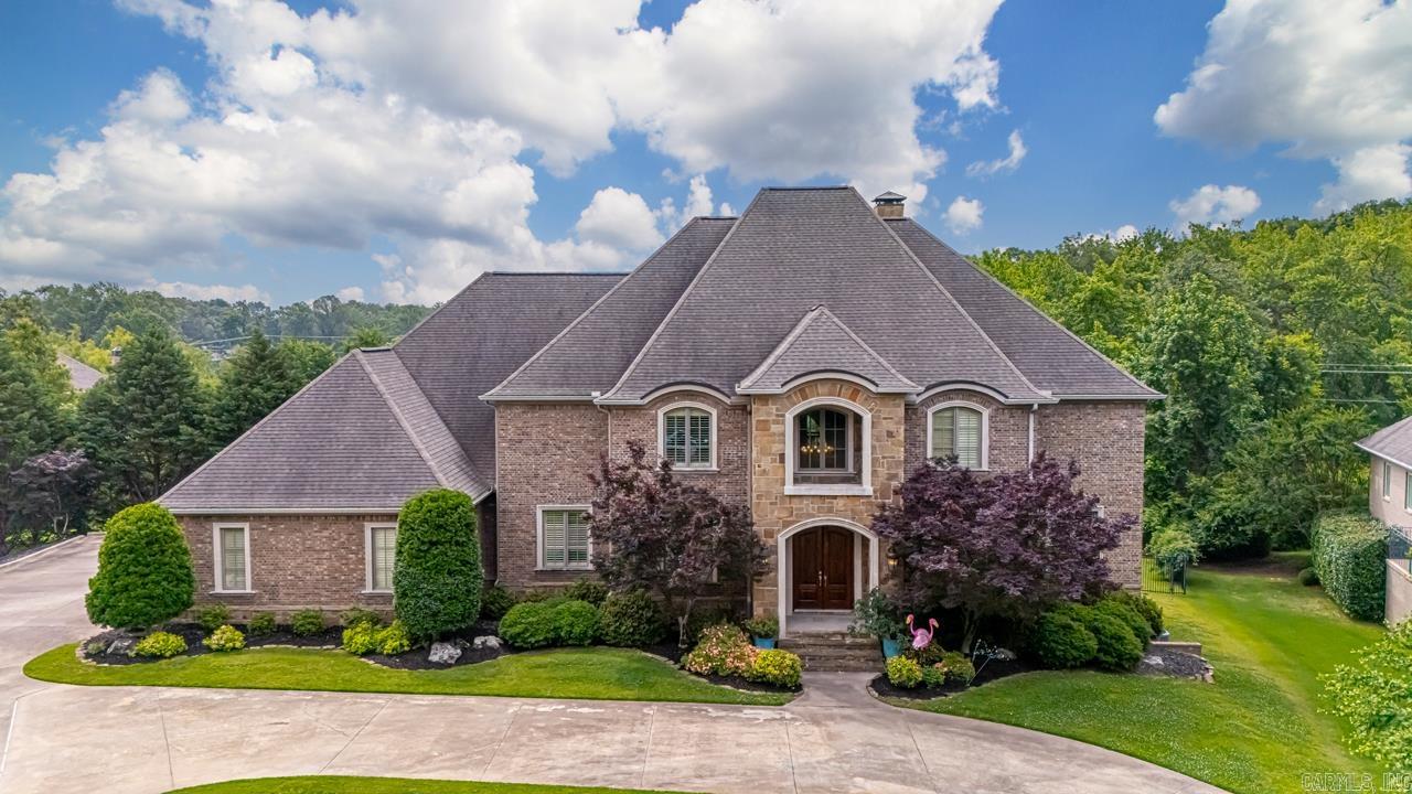 Impressive 3 level spacious home w designer touches on 1.5 acres in a desirable, gated NLR neighborhood.  Convenient to shopping w easy access to interstate.   Main level boasts the primary suite and guest suite, large kitchen with island- perfect for the chef in your family!  A wet bar w icemaker and beverage fridge, breakfast bar and breakfast area, also a separate formal dining room.  20' ceiling entrance and living space flowing onto private covered patio overlooking pool.  Stunning coffered ceiling office w built-ins.  Upstairs offers 3 more BR (or 2 BR suites and a flex room), 2 baths and a theater room with new projector.  Downstairs hosts another BR suite (perfect in-law or teen suite), 1//2 bath, living space and a flex room, leading out to another private covered patio flowing to the pool area. Huge storage area accessed from inside or outside the home with a double door entry from outside.  More impressive storage under the home. New pool liner '18, added heater to pool in 2019, New pump Jan '25.  Lighted sport court added in '12.  2 New HVACS in Nov '24.  New hardwoods in primary and guest suite '19 and New LVP flooring down in '19. New SS fridge '23. A Must See!