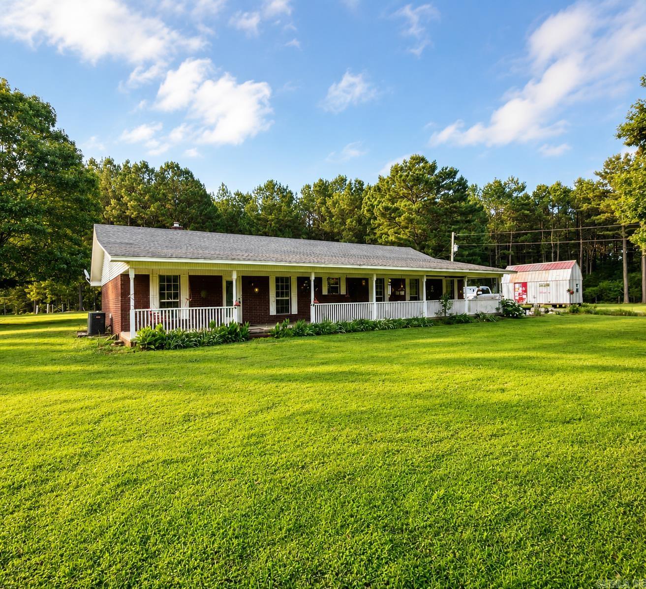 Escape to the peace and privacy of country living with this charming 3-bedroom, 2-bath home situated on 4 beautiful acres. Offering 1,737 square feet of comfortable living space, this property is packed with features designed for both convenience and self-sufficiency. Enjoy relaxing on the spacious covered front porch while taking in the serene surroundings and abundant wildlife. Inside, you'll find beautiful oak cabinets, wood blinds throughout, and a functional layout perfect for everyday living. Major updates include a 3-year-old HVAC system and a new 50-gallon water heater for added peace of mind. Outside, a 12x20 shed/workshop with two lofts provides excellent storage or workspace, while city water is complemented by a functioning backup well. Additional features include fiber internet for high-speed connectivity and a steel attic ladder for easy access to extra storage. Combining privacy, modern conveniences, and room to spread out, this property offers the ideal blend of country living and comfort. Don't miss this opportunity to own your own private retreat—inventory remains low, and properties offering acreage, privacy, and this many upgrades don't stay available for long.