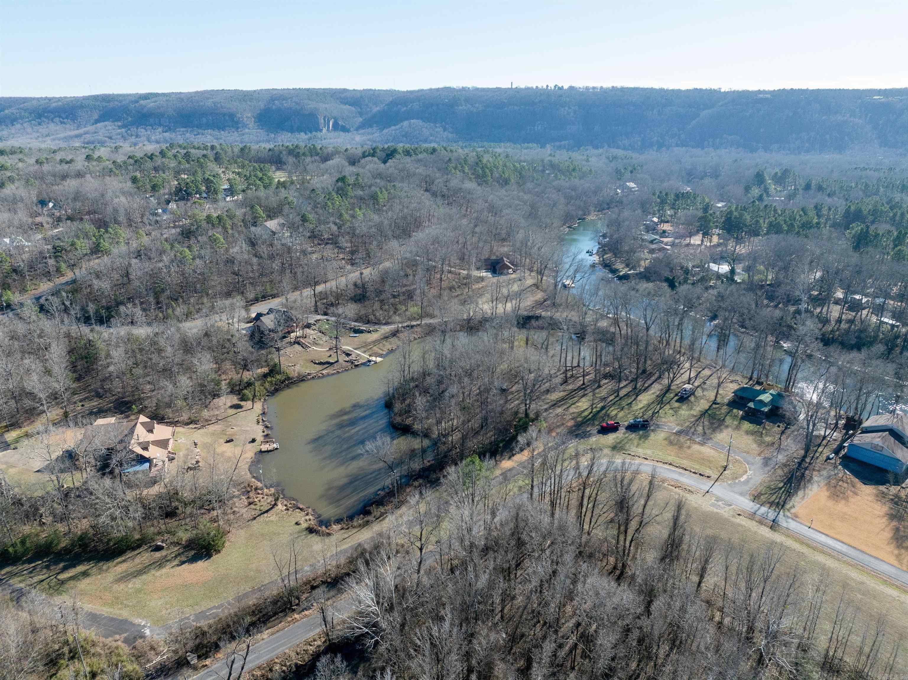 RIVER FRONTAGE, AIRSTRIP Property & OWNER FINANCING at 4% with 20% down, 15 year amortization schedule with a 4 year balloon. Subdividing options. Riverfront Cabin Retreat with AIRSTRIP, Dock & Trout Fishing. Discover a rare opportunity to own a riverfront cabin on 10 acres, offering not only exceptional recreational amenities but also outstanding development potential. The 3-bedroom, 1-bath cabin provides a comfortable base for weekend escapes or full-time living. Surrounded by nature, the setting is peaceful and private, with sweeping river views and abundant wildlife. The river is well-known for excellent trout fishing, making it a dream for anglers. Enjoy easy water access via the community dock, perfect for kayaking, floating, or fishing. A private lake offers another serene outdoor feature and added recreational value. A unique highlight is the 2500' grass airstrip, making this an ideal fly-in property. With additional acreage available, the land presents great opportunity to tie into an existing community sewer system—ideal for expanding a private estate, adding cabins or rentals, or creating a small river access community.