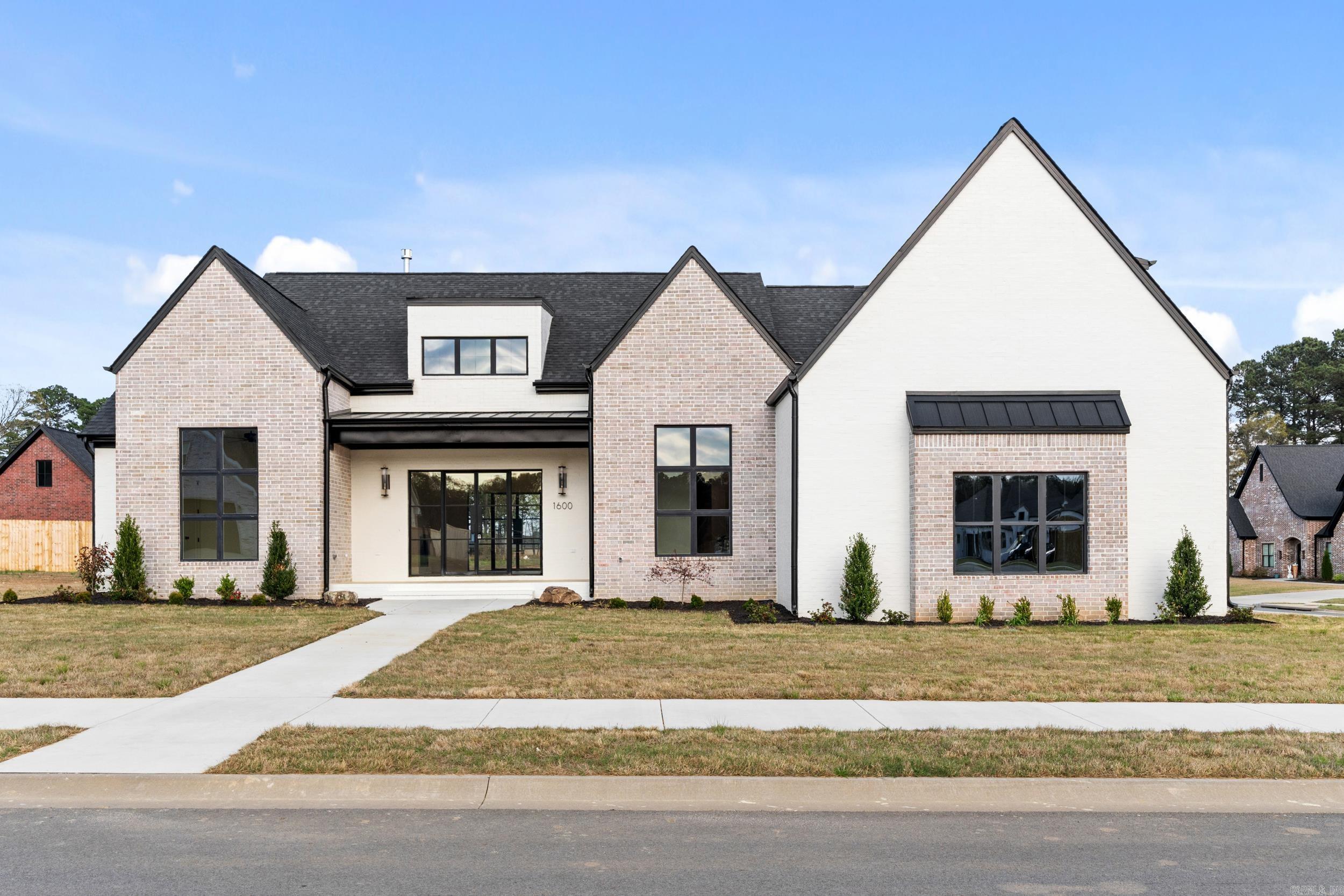 All the features of a top-end Drew Hester custom home - none of the hassle of building! This spectacular new construction truly has too many highlights to list them all; a huge hidden pantry, decorative hardwood floors, custom white oak cabinets, a shower and bath wet room, and incredible natural light through the iron and glass doors (with thermal break). Every detail has been painstakingly crafted to build one of Conway's finest homes.