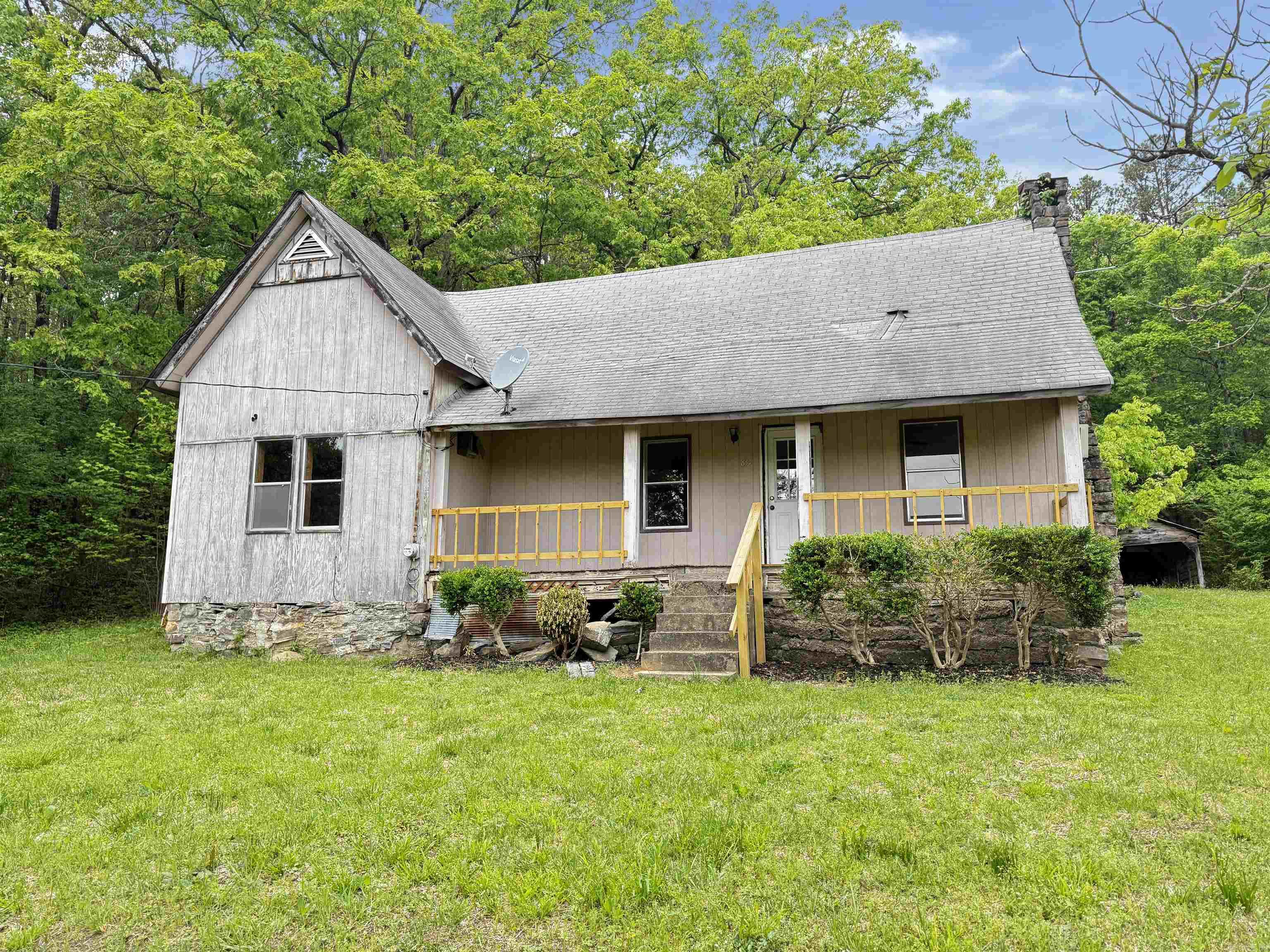 Looking for privacy and a peaceful retreat? This charming older farmhouse sits on 4.34 mostly wooded acres along a private drive, offering the perfect escape from the hustle and bustle. With over an acre cleared and ready for a garden, the property provides both seclusion and usable space. The home features 2 bedrooms, 1 bath, a spacious living area, and a separate dining room. Relax and enjoy the surrounding nature from the inviting front and back porches. Conveniently located just minutes from Hot Springs, AR,  and Lake Ouachita. This property is ideal as a full-time residence or a relaxing getaway. Being sold AS-IS.  Photos edited by Efurnished for clarity.