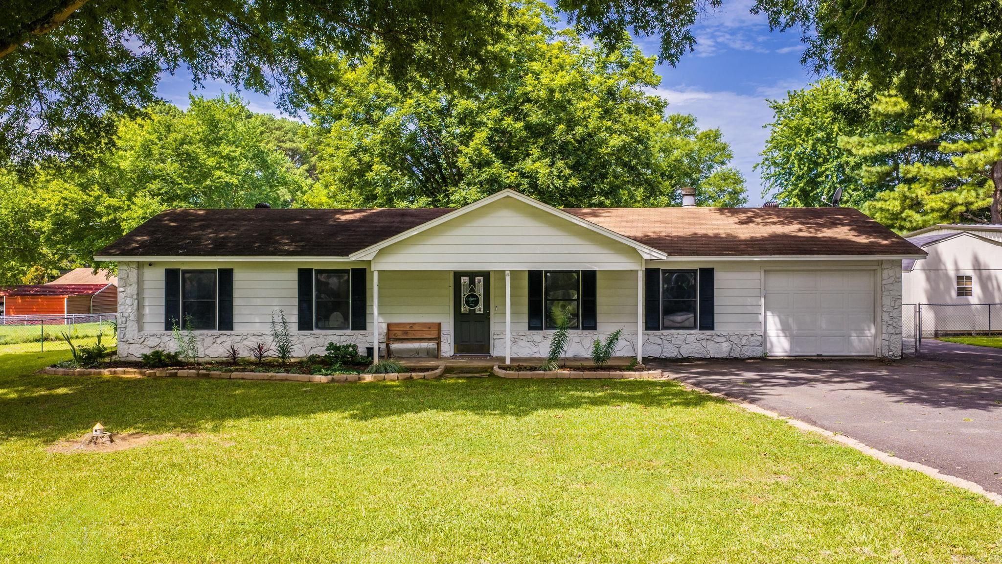 Welcome home to this charming 3-bedroom, 2-bath property situated on a spacious lot that is approximately 1/2 an acre.  Inside, you'll love the Luxury Vinyl Plank flooring throughout the living area and kitchen, offering both style and durability. The open living spaces are nice, making the home warm and functional for everyday living.  Step outside to a large, flat backyard featuring a covered back patio along with a cozy fire pit and fully fenced yard.  An added bonus is the abundant extra parking, providing plenty of space for guests, recreational vehicles, or other vehicles.  This home also shows be eligible for a Rural Development Loan.   With its combination of indoor comfort, outdoor living, and generous lot size, this home is one you won't want to miss!  Shed in the backyard does not convey.  NEW ROOF Coming Soon!