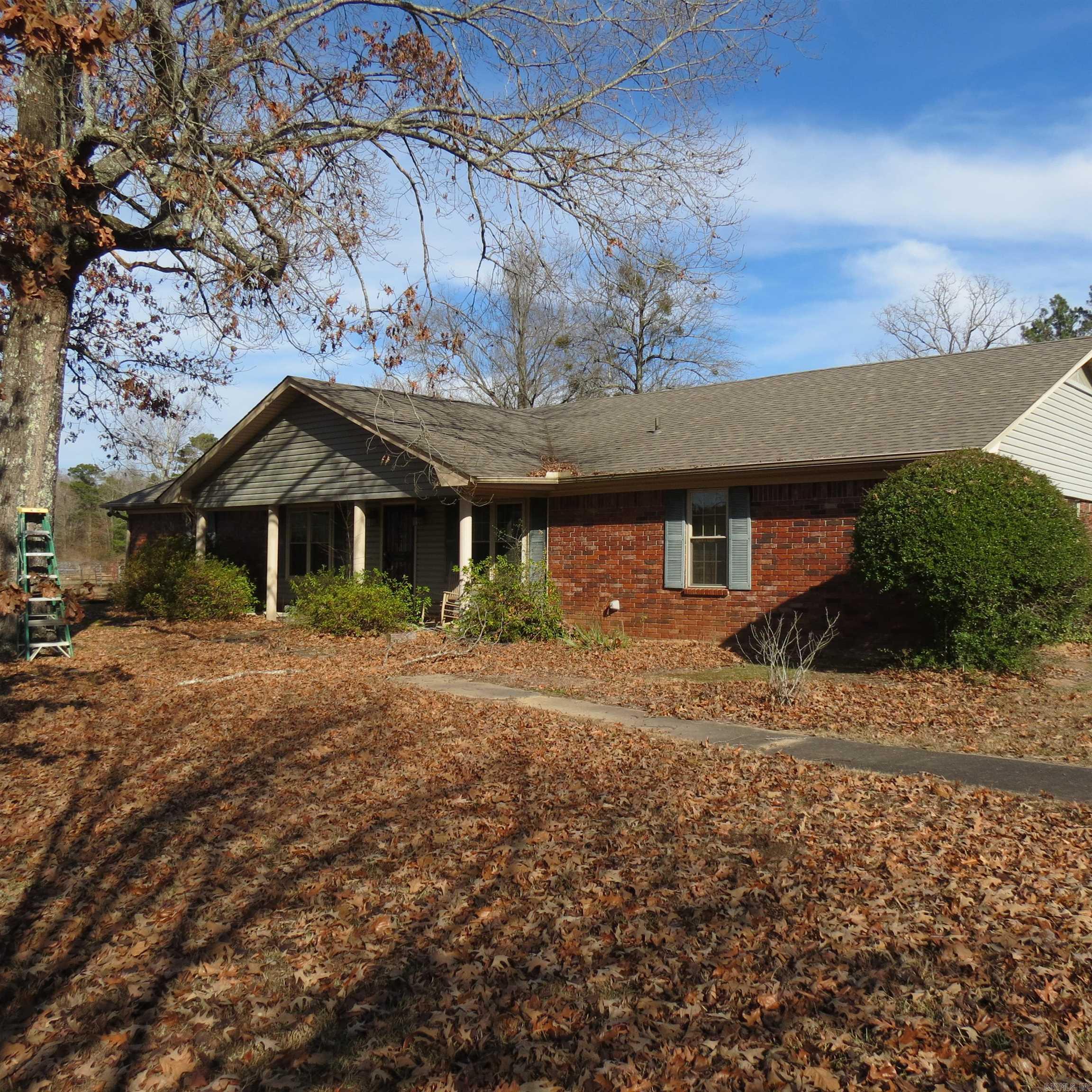 This charming brick home sits on a sprawling 36 acres with tree lined driveway, fenced pastures, pond, barn, equipment sheds, and a bunk house.  This property is designed for those who crave wide open spaces, privacy, room to work and grow.  This is a solid home with vaulted ceilings, fireplace, 2 living areas, dining area, split floor plan.  Bunk house is perfect for guests, in laws, man cave or studio.  Barn has stalls, tack room, tractor sheds, fenced, cross fenced, pond for livestock.  Plenty of room for a garden.  Call today for your private showing.  Agents please see remarks.