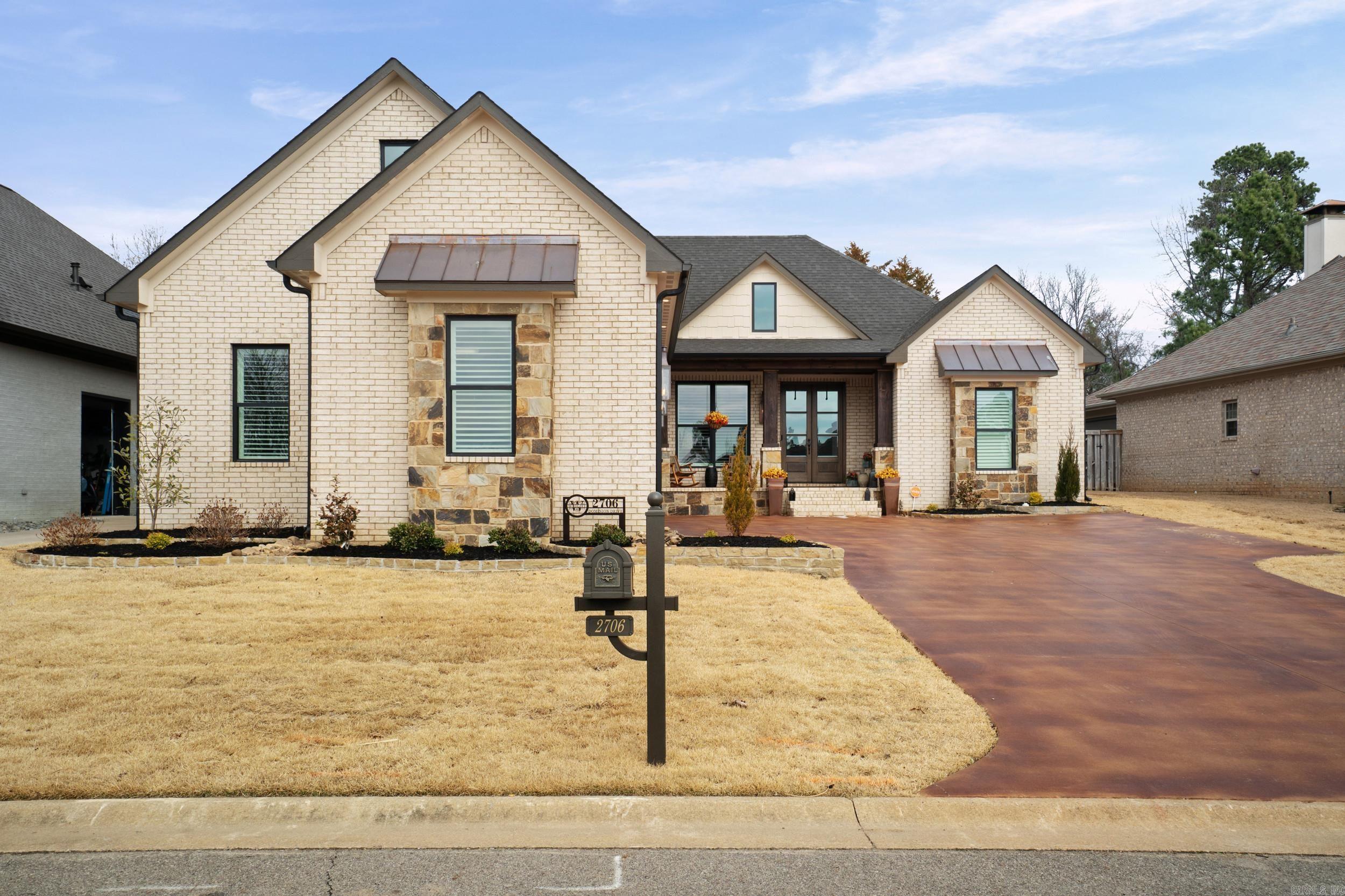 This masterfully custom designed stone and brick home located in a gated community across from the Searcy Country Club. This home offers a blend of craftmanship and comfort with open-plan design which transitions perfectly from indoor luxury to outdoor relaxation. Great room offers wood floors, dramatic beamed ceilings and a floor-to-ceiling stone fireplace. Chef-inspired kitchen fully equipped with high-end appliances including a Miele coffee maker and large island for entertaining. Split floor plan features 3 BR, 2.5 baths with oversized primary suite with a dedicated sitting area and private entrance onto the amazing patio. The compact home office is a high-demand feature. Spacious laundry area with abundant storage and brick tile. Plantation Shutters. The outdoor living area is sheltered by a beautiful wood-planked ceiling, stone fireplace and outdoor kitchen. Garage features Versa Attic Storage Lift. Generator. Schedule your private tour today to experience this custom masterpiece in person. SEE AGENT REMARKS!