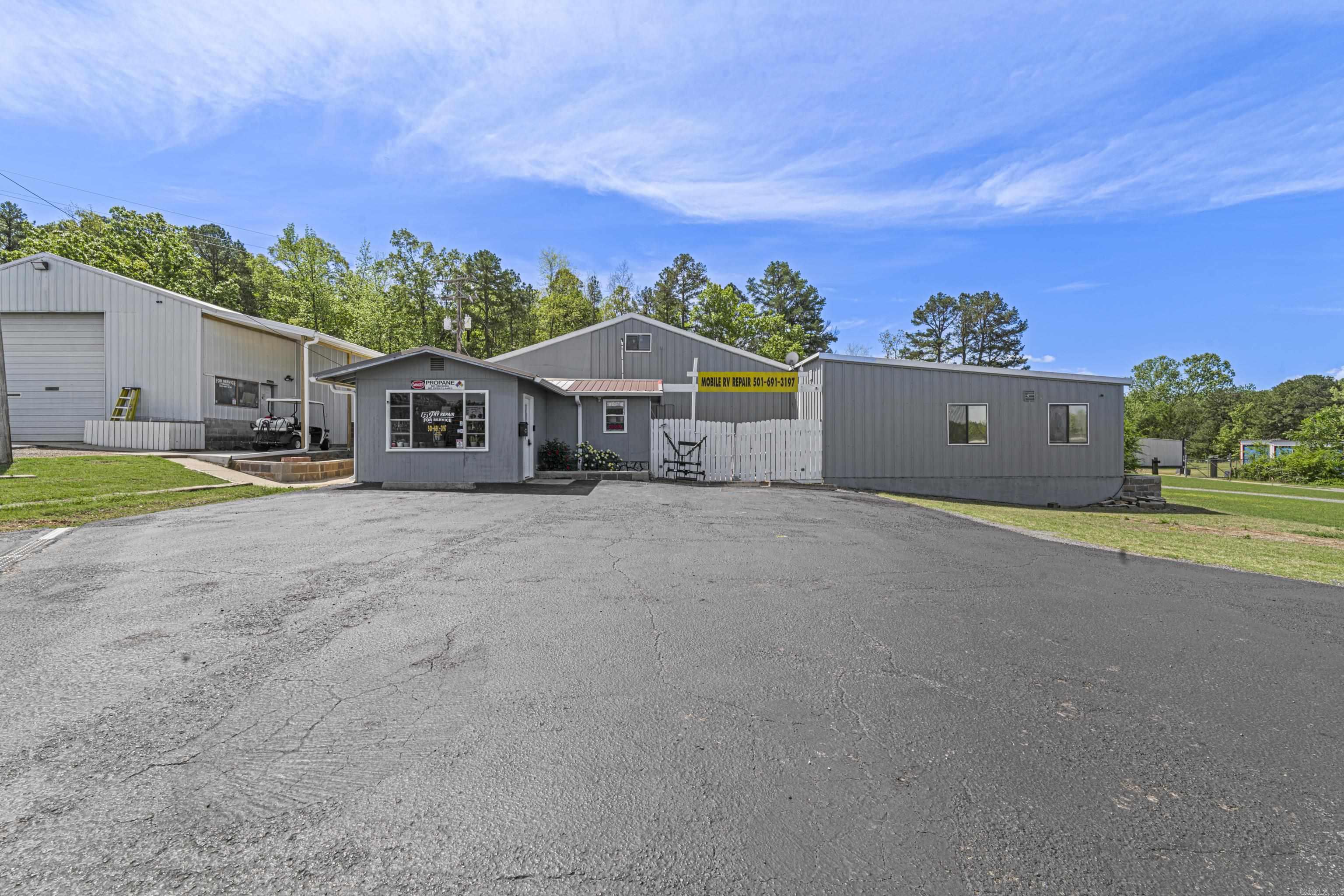 COMMERCIAL WITH RESIDENTIAL SPACE!!!!  Don’t miss this incredible investment opportunity in a high-traffic location near Dam Site Park and all the amenities Heber Springs has to offer. This thriving commercial property, currently operating as a successful Mobile RV Repair business, offers exceptional versatility and income potential. Spanning a total of 12,540 square feet, this well-maintained property includes: Two spacious garage bays perfect for repair or service operations. Retail storefront and office space ready for customer engagement. A large 1,920 sq ft attached apartment featuring a private entrance and a generous deck for relaxing or entertaining. Nine separate storage units, providing extra rental income. Covered parking and ample lot space for customers or business vehicles. Whether you're looking to continue the existing business or launch your own, this property is ready to go. The current business’s inventory is negotiable, making this a seamless transition for the right buyer. Take advantage of this rare find in a highly desirable location — a blend of commercial opportunity, residential comfort, and steady rental income all in one!