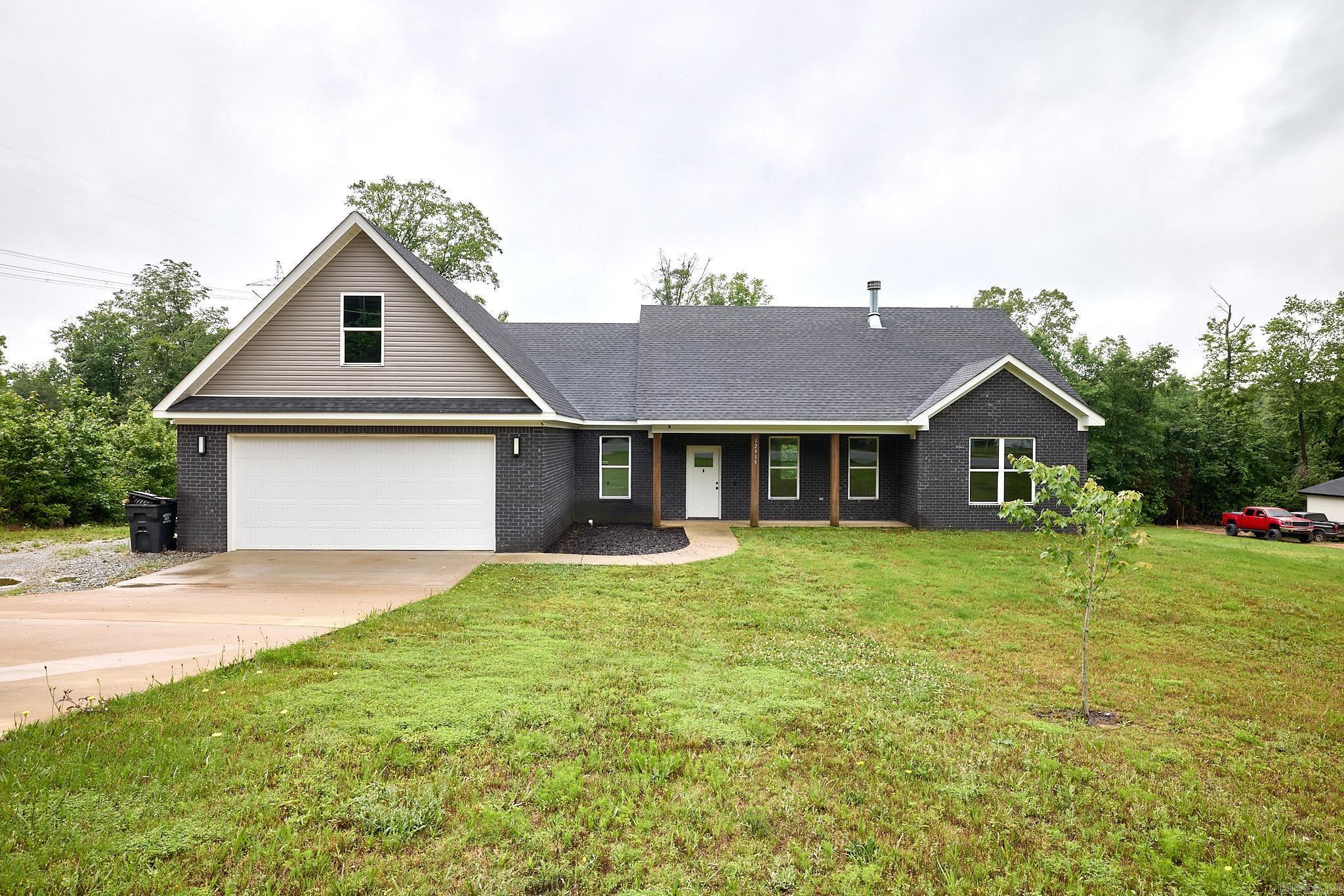 Welcome to this stunning single level country home situated on 2.76 acres. This cozy 3 bed and 2.5 bath home was built in 2023 and offers a thoughtfully designed split bedroom floorplan with a separate carpeted bonus room with a closet over the garage that could function as a 4th bedroom. The space offers privacy and functionality for the whole family. The heart of the home is an open concept living, dining and kitchen area-perfect for everyday living and entertaining alike. Gather around the gorgeous fireplace flanked by beautiful built in cabinetry on each side adding both charm and character. Soaring pan ceilings add an airy, grand feel throughout the main living space, while rich luxury vinyl plank flooring flows seamlessly underfoot. The primary bed offers wonderful space with a separate shower and tub in the private bath area. Step outside and enjoy the freedom and serenity that only acreage living can offer. This all brick home offers the both of best worlds, just far enough from town to create a feeling of country but close enough to town for a quick trip to eat out or run errands for necessities. Make an appointment to view this country cozy home today!
